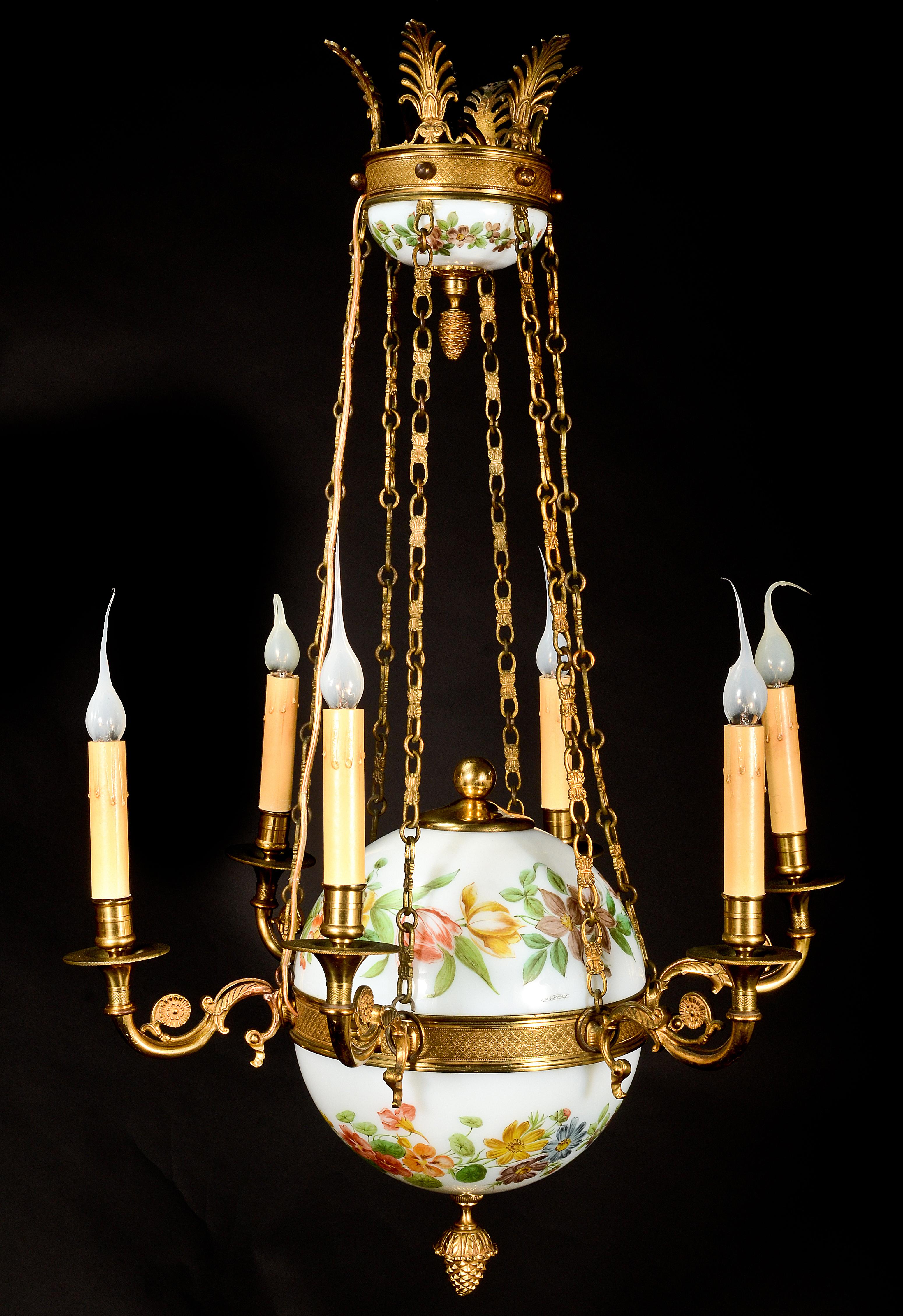 A fine antique French Charles X style gilt bronze and white opaline glass ball form multi light chandelier of superb quality embellished with hand painted polychromed enamel depicting flowers and further embellished with gilt bronze chains and