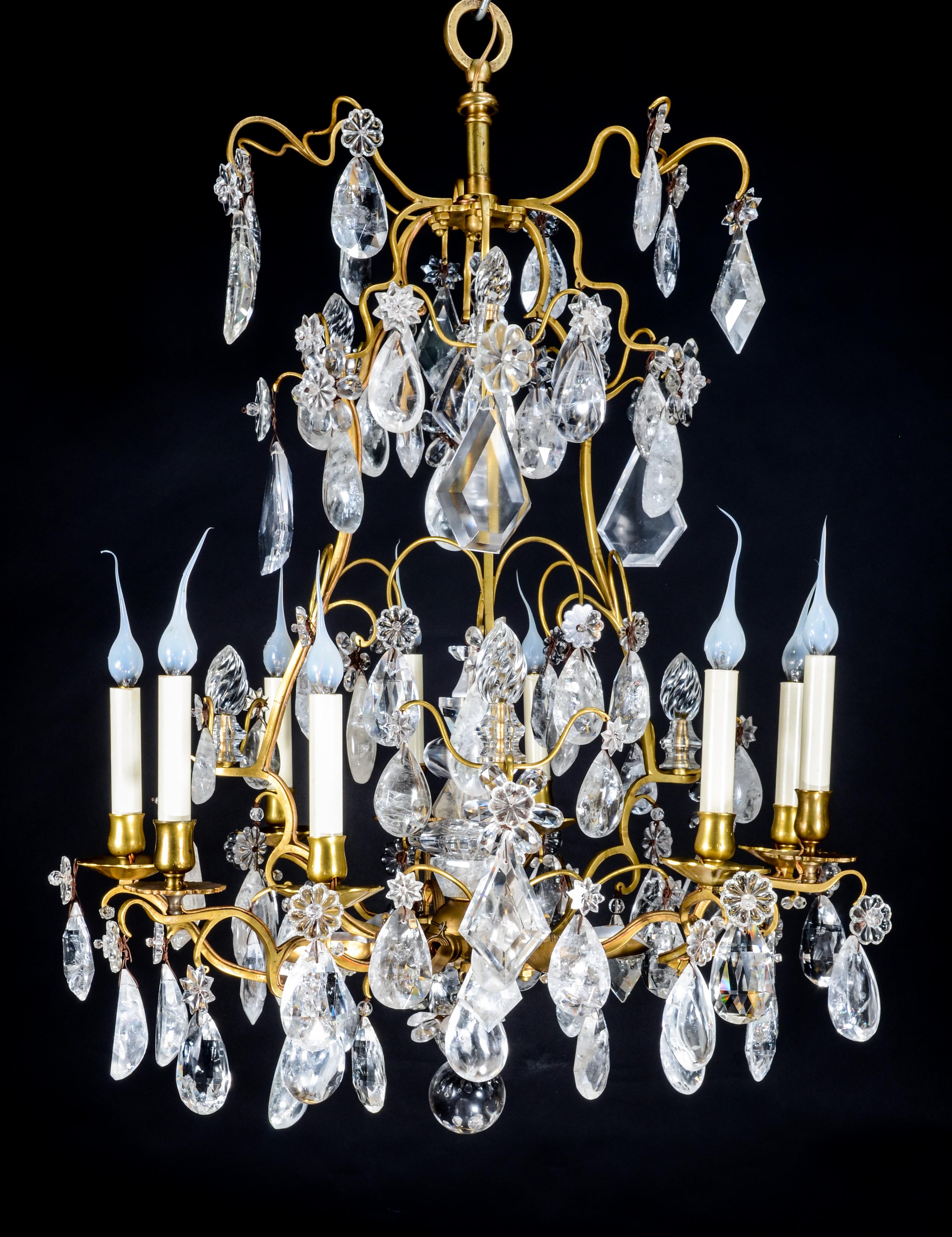 A fine antique French Louis XVI style gilt bronze and cut rock crystal cage form multi light chandelier embellished with fine cut rock crystal prisms, rock crystal finials and further adorned with a central multi part cut rock crystal obelisk.