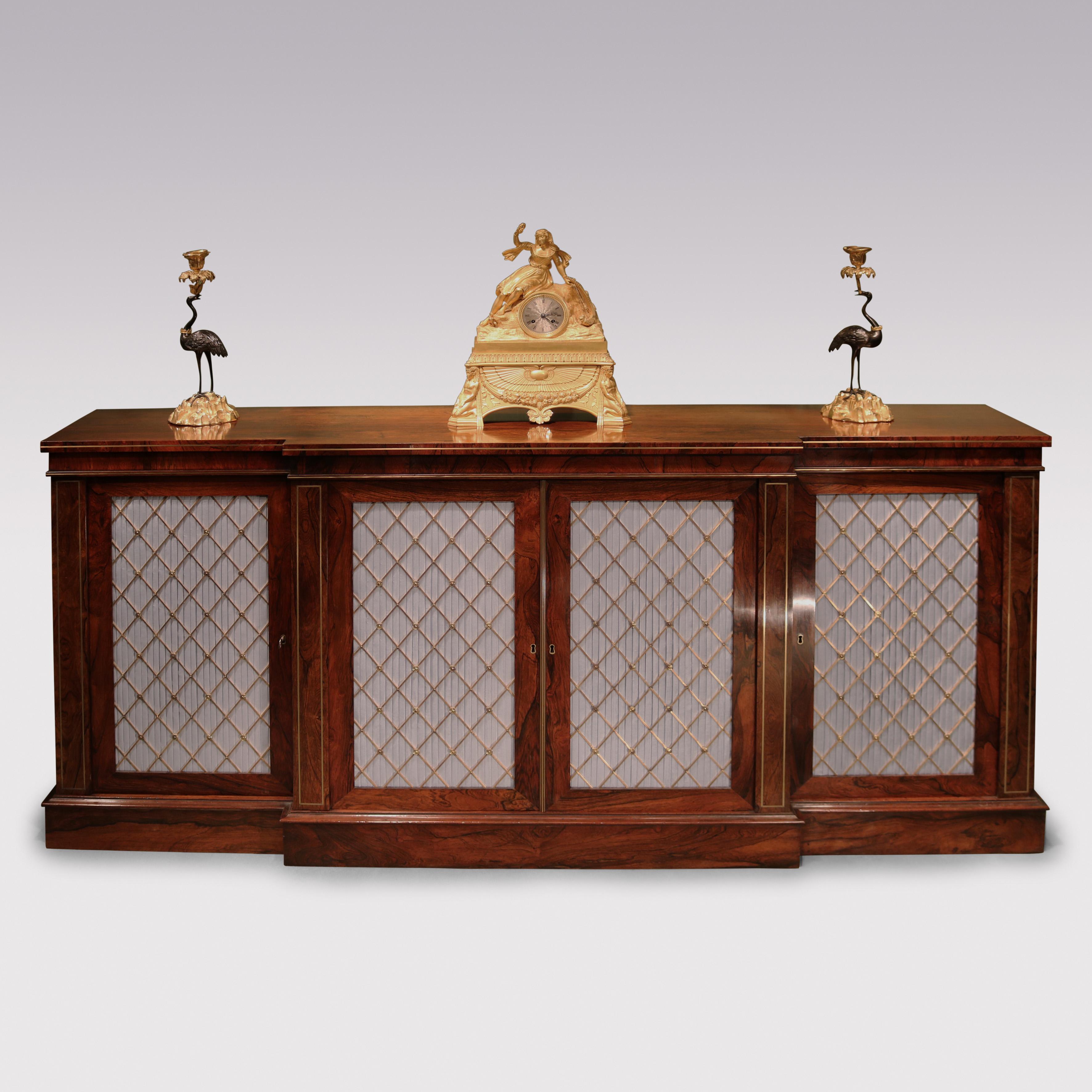 A fine quality early 19th Century Regency period rosewood breakfront Chiffonier, having brass line inlaid edge above blue moire silk & brass grille doors flanked by further brass line inlaid columns supported on plinth base.