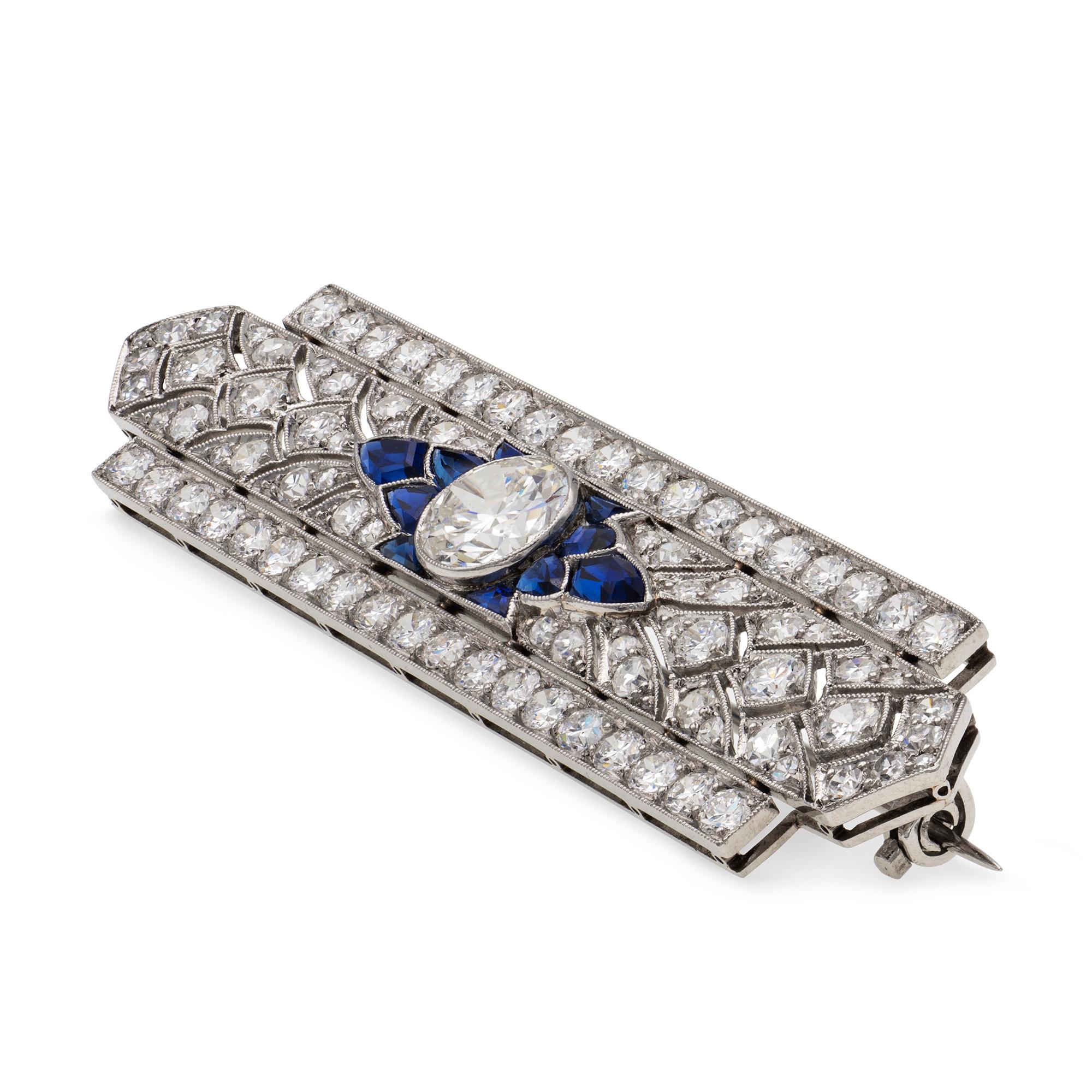 A fine Art Deco diamond and sapphire bar brooch, to the centre a transitional brilliant-cut diamond estimated to weigh 1.75 carats, assessed colour H-I, assessed clarity VS1-2, set between five fancy-cut sapphires on each side, to an openwork