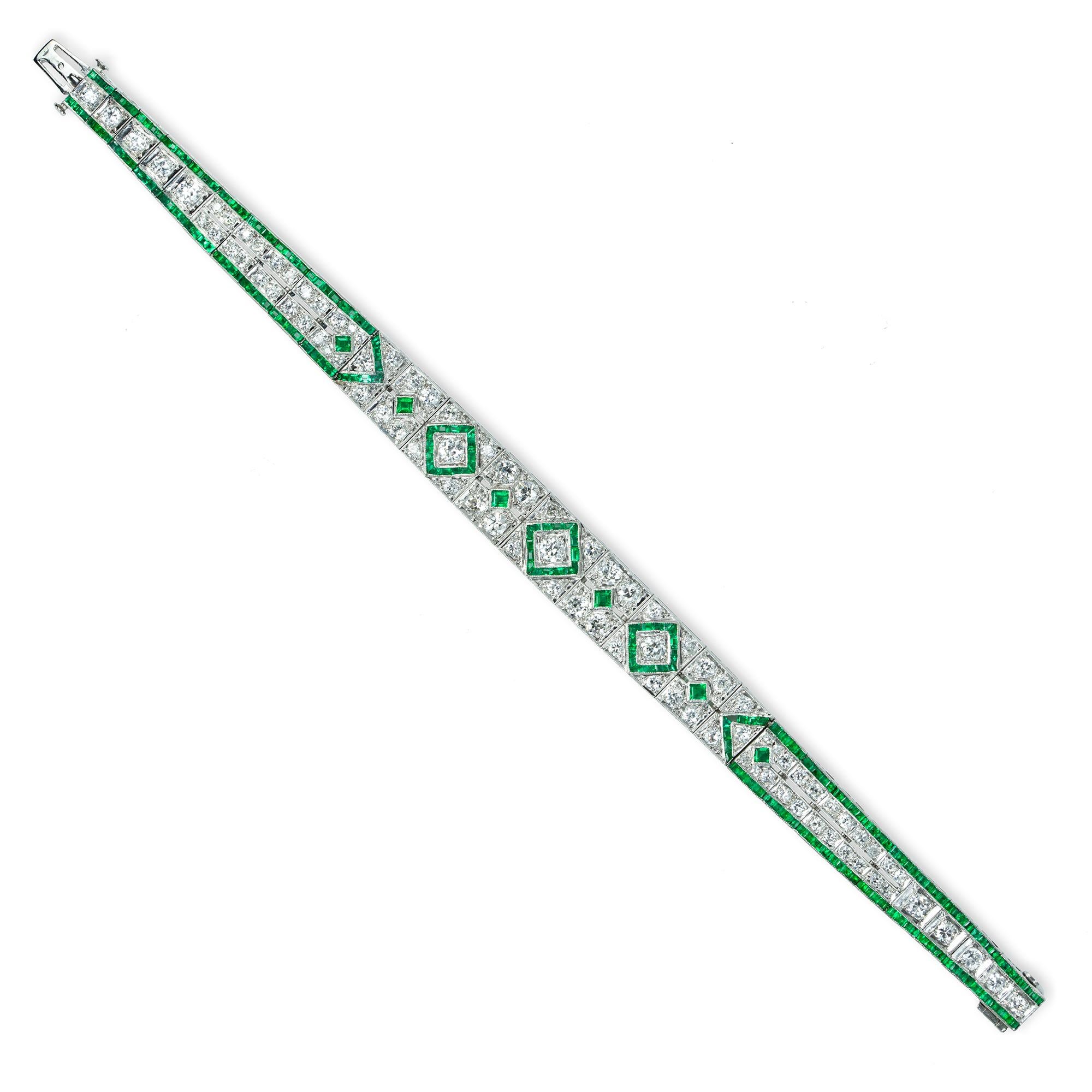 A fine Art Deco emerald and diamond bracelet, the twenty eight openwork panels of geometric design set calibre-cut emeralds weighing approximately a total of 1.20 carat and old cut diamonds weighing approximately a total of 4.75, all set in