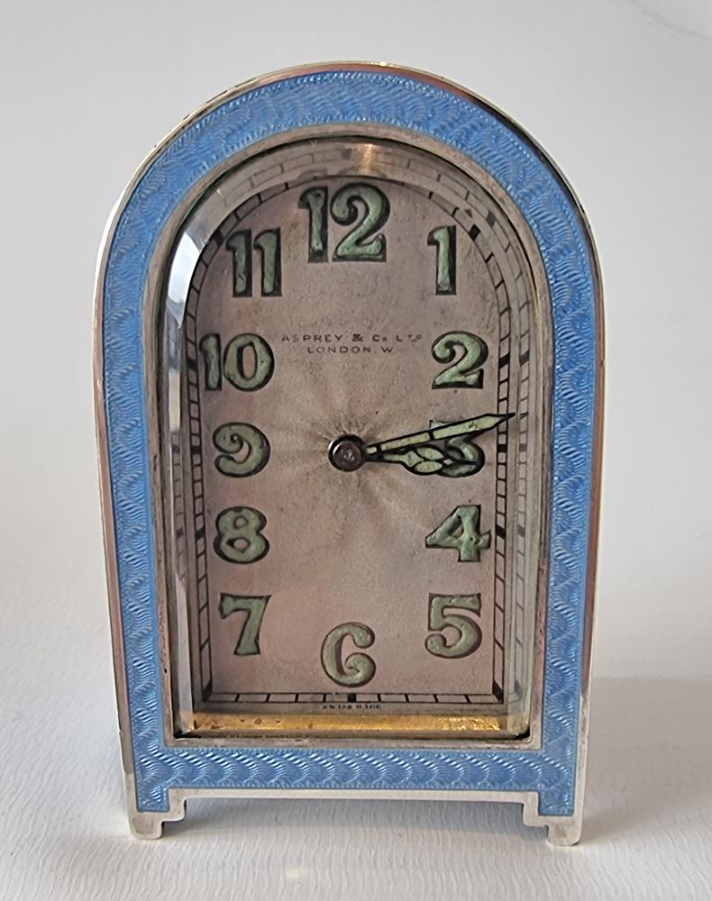 A magnificent boudoir clock in silver and blue guilloche enamel by  the Crown jewellers Asprey.  The superb engine turned wavy guilloche enamel in mint condition. Of domed top form the lovely enamel covers both sides and the dome top and in a thin