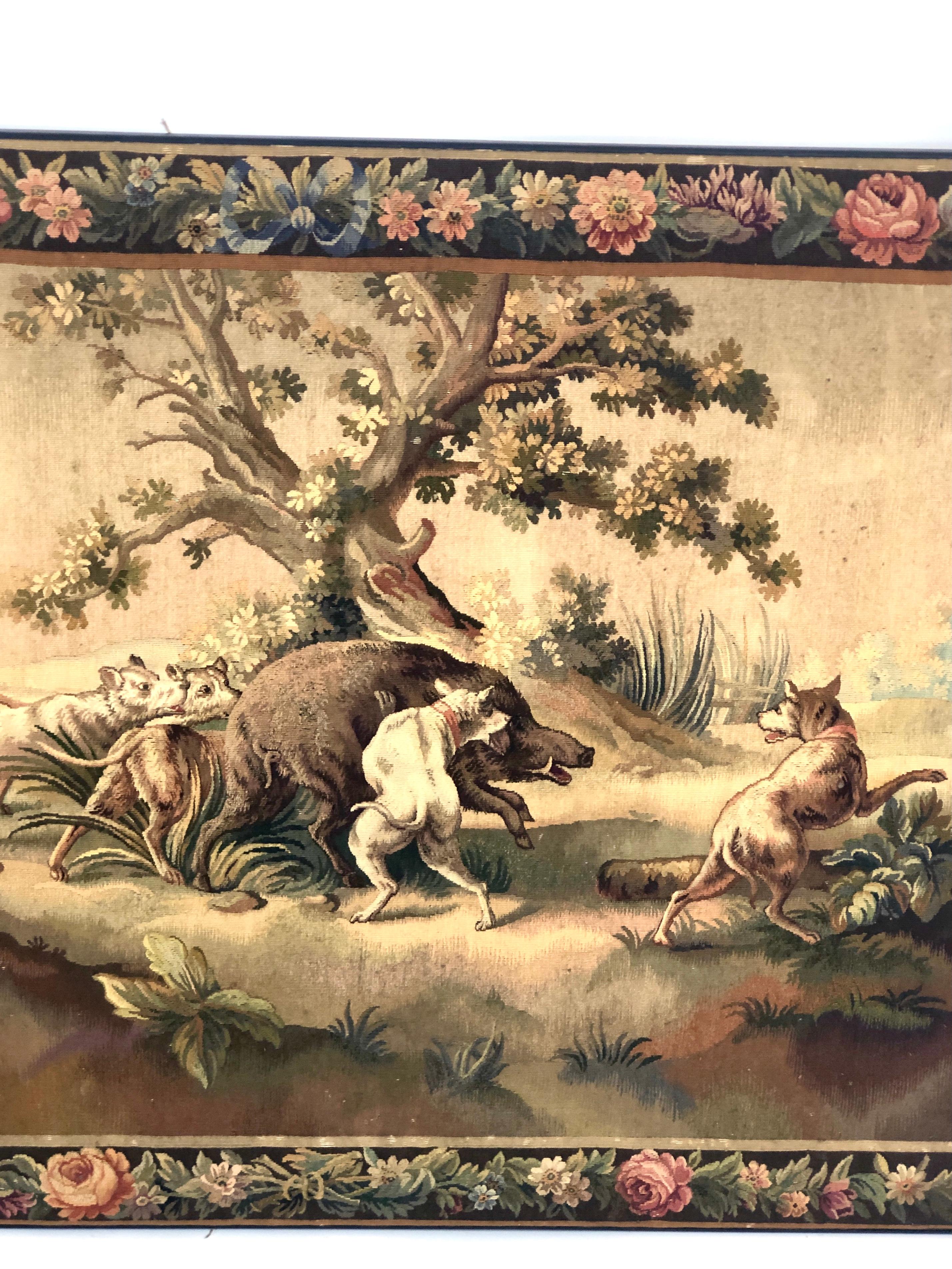 A fine Aubusson pastoral tapestry depicting dogs hunting a wild boar in a typically rural landscape. The woven tapestry is signed “Aubusson” on its left side. Some small blemishes, in keeping with its age. 

The small French town of Aubusson, on