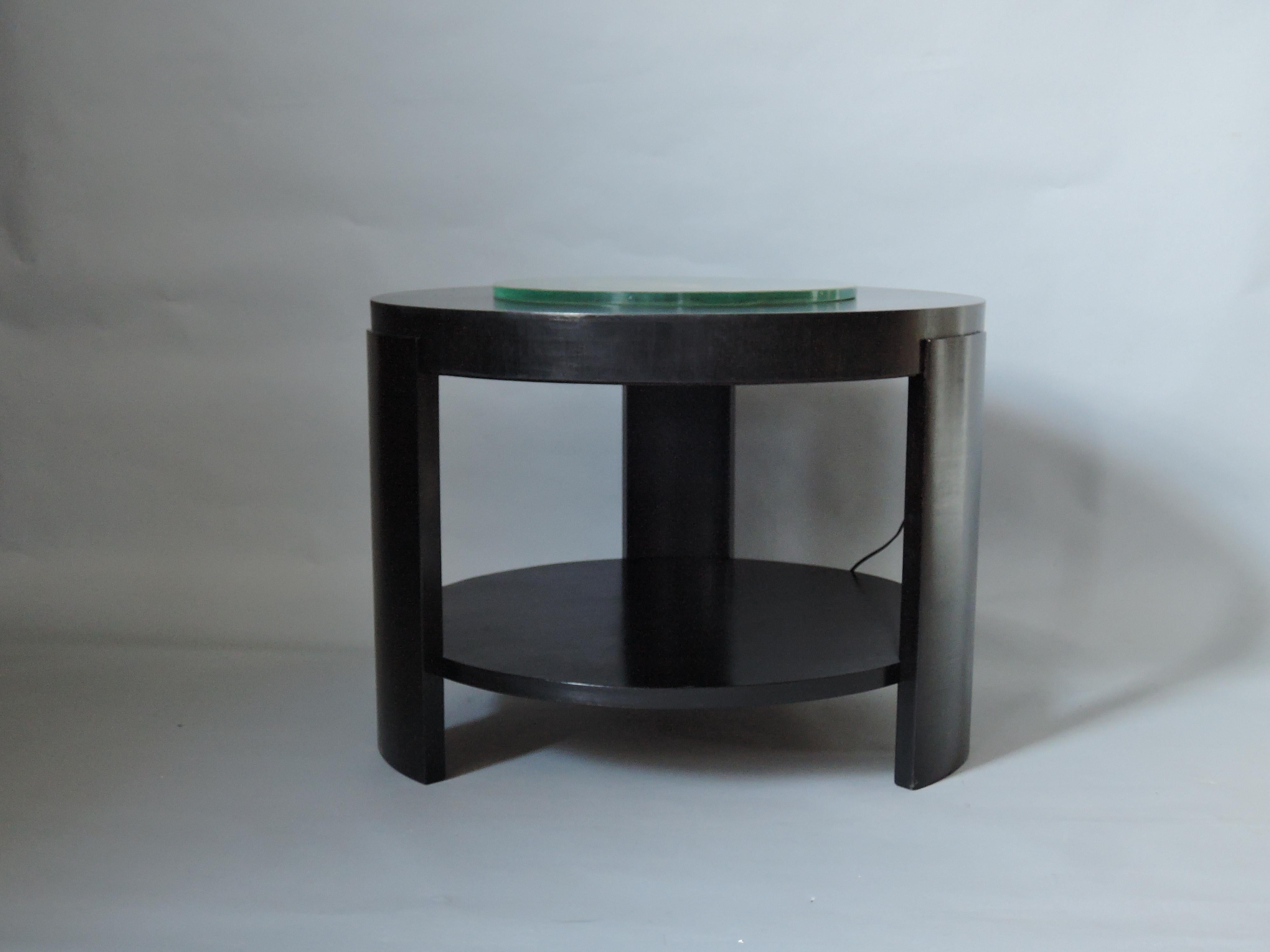 A rare Art Deco Belgium two-tier illuminating ebonized walnut gueridon/side table by De Coene with a centre glass slab.
Historic: Model presented at the 1935 Exposition Universelle in Brussels 
Bibliography: Collectif, 