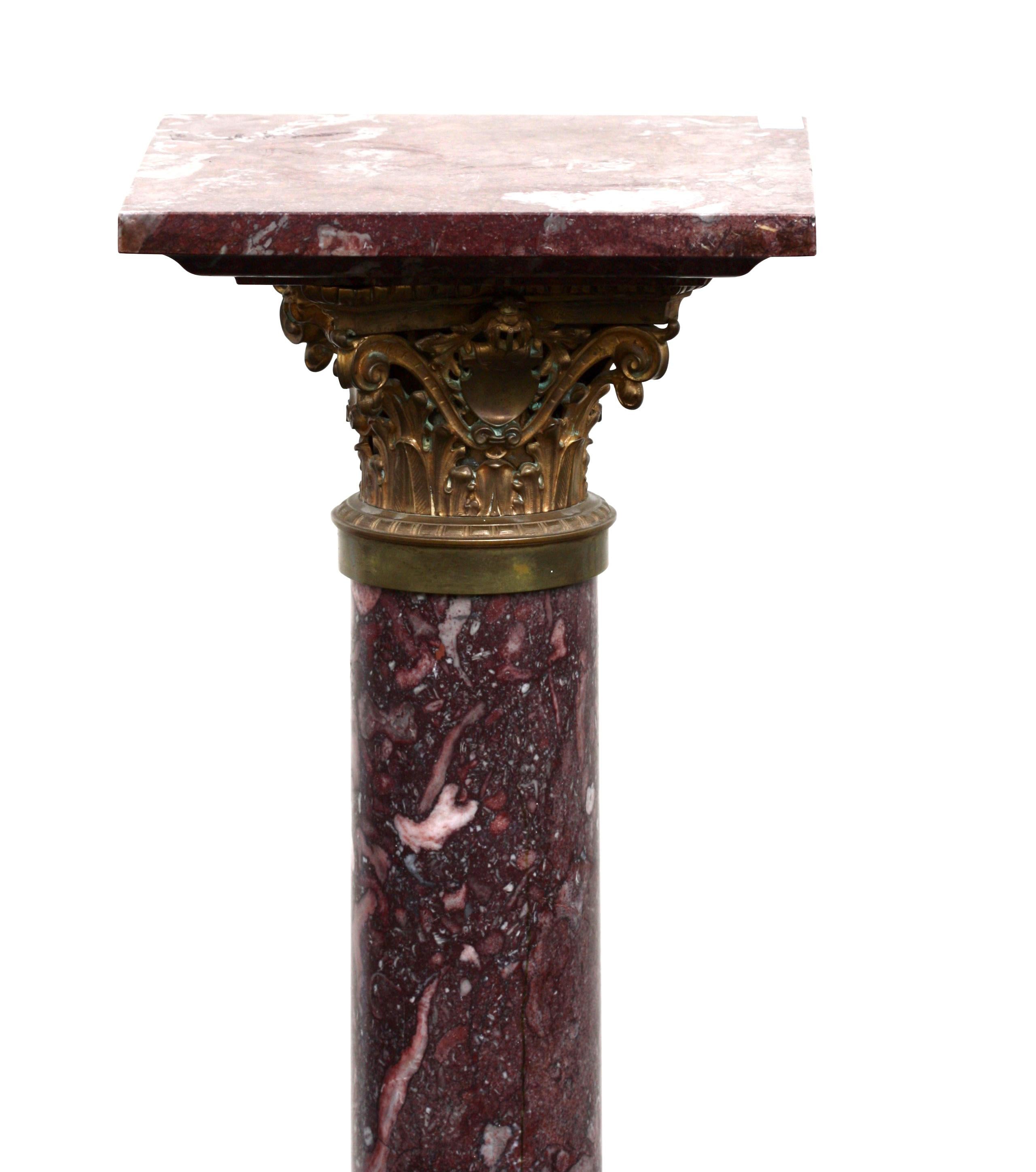 A fine black and rouge marble pedestal column, late 19th century, with gilt bronze mounts,
Measures: Height 43 in. (109.22 cm.), top 11 x 11 in. (27.94 x 27.94 cm.), base 12 by 12 in. (30.48 x 30.48 cm.)