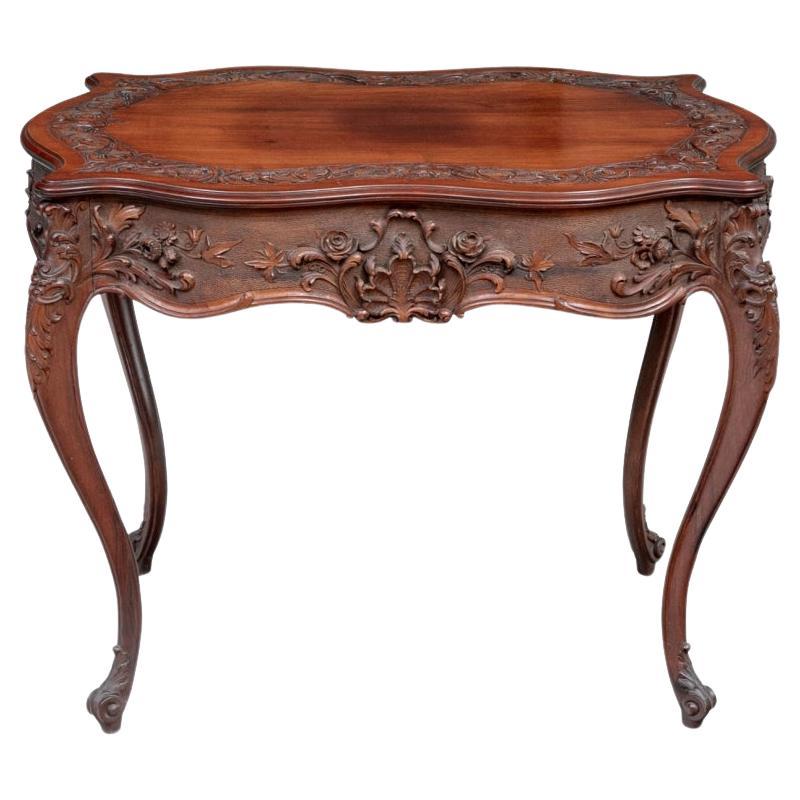 A Fine Carved Turtle Top Parlor Table