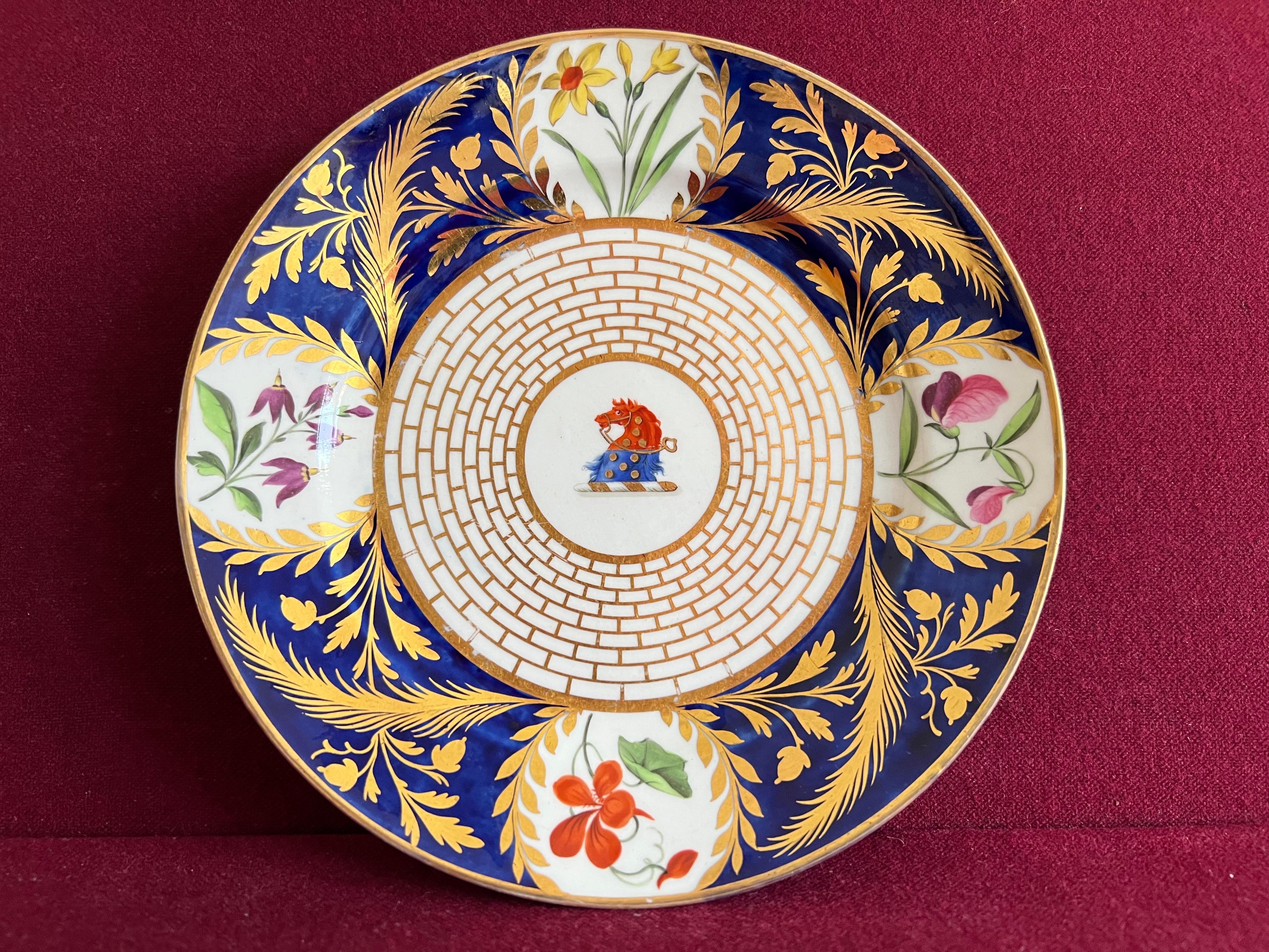 A fine Chamberlain Worcester porcelain dessert plate c.1815. Finely decorated with an armorial crest to the central well of the plate and gilt brickwork. The flange of the plate decorated with a cobalt blue ground and roundels containing flower