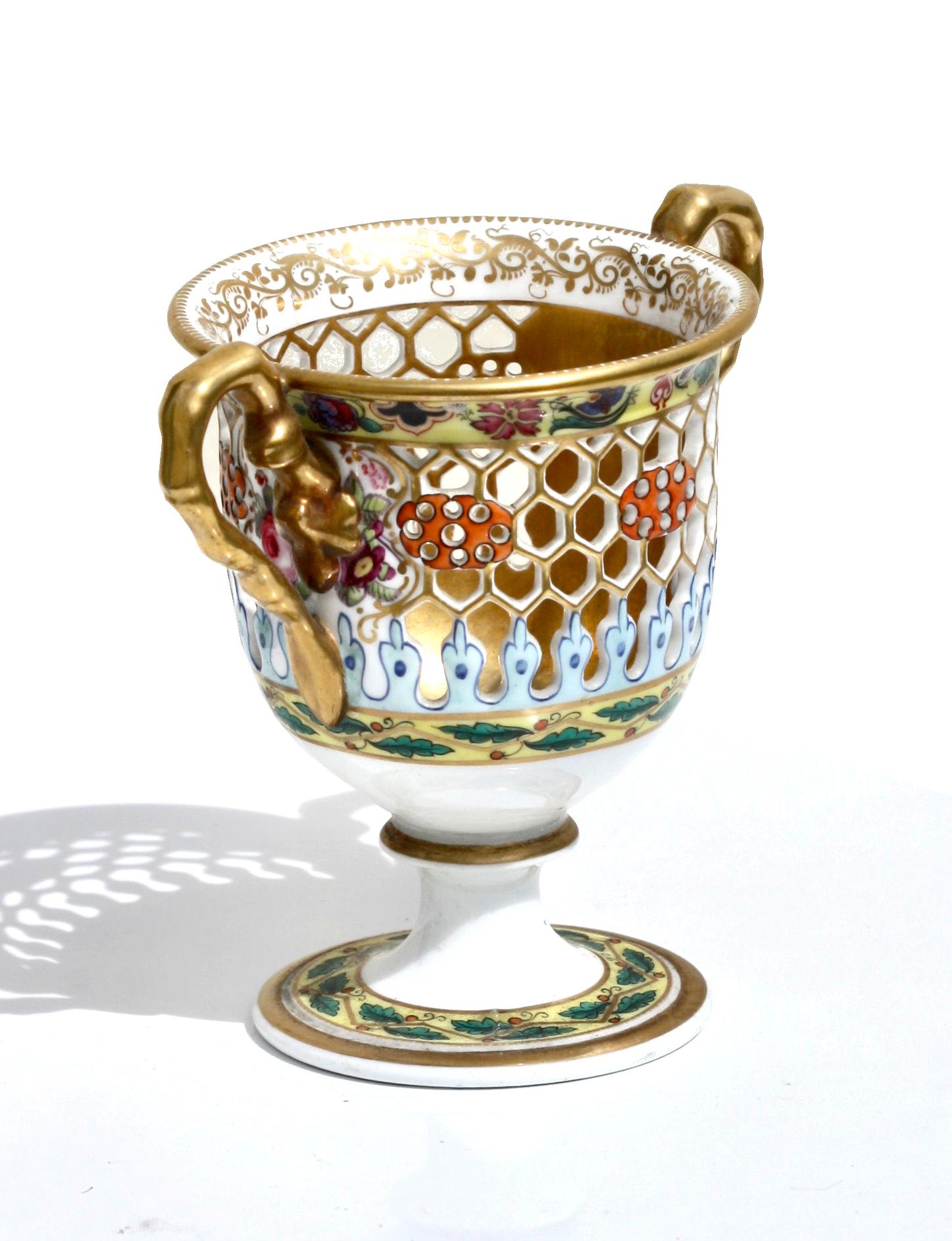 A fine Chamberlains Worcester reticulated porcelain cup, 
English, 1847-1850. 
Printed factory mark, of urn form with branch shaped handles, raised on a pedestal base. 
Measures: Height 3.87 in. (9.84 cm.), 
Width 4.25 in. (10.79 cm.).
   