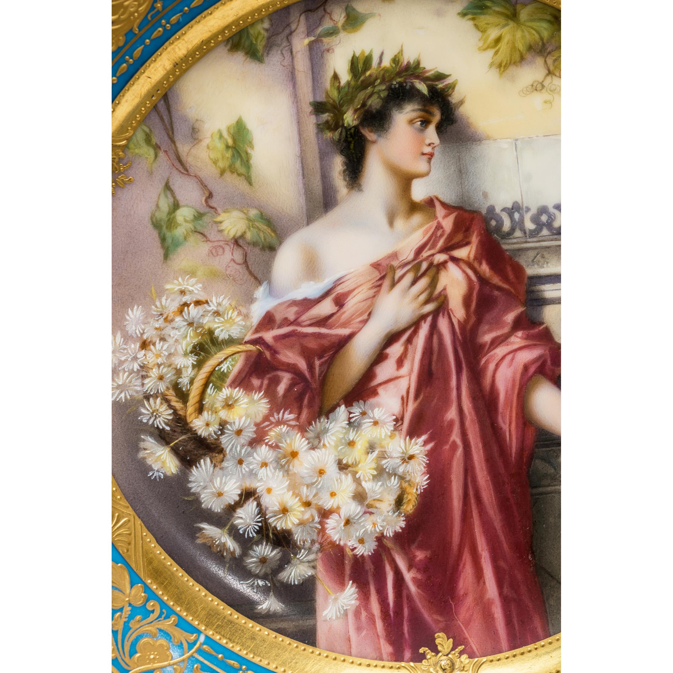 Exquisite Royal Vienna portrait porcelain gilded cabinet plate featuring hand-painted portrait of a beautiful young Grecian woman with a basket of flowers. The turquoise border finished with gold trim. Marked on verso with the Royal Vienna Blue