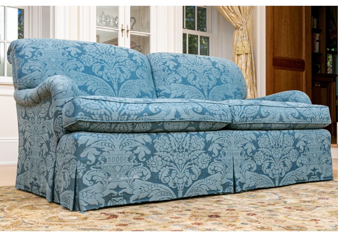 A very well made Sofa with rolled arms, and back, fixed back cushions and large fitted seat cushions.. The Sofa is upholstered in a soft pleasing Blue Cotton type blend in Damask style Floral print. Nice balanced cushioning with great comfort. 