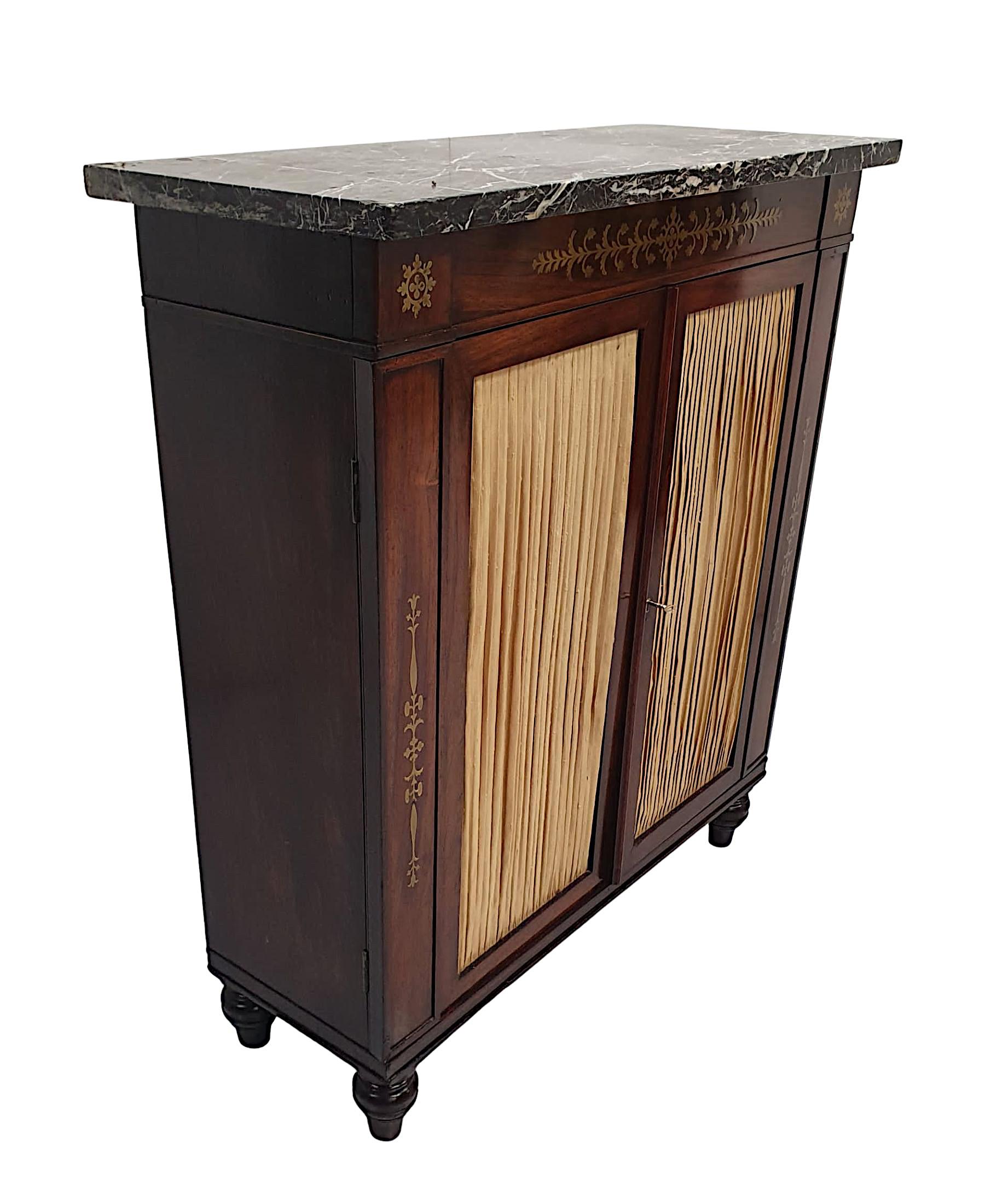A fine early 19th century Regency fruitwood marble top side cabinet of exceptional quality, beautifully hand carved with rich patination, fine grain and brass mounted throughout. The gorgeous, moulded Marquina Black marble top raised over frieze