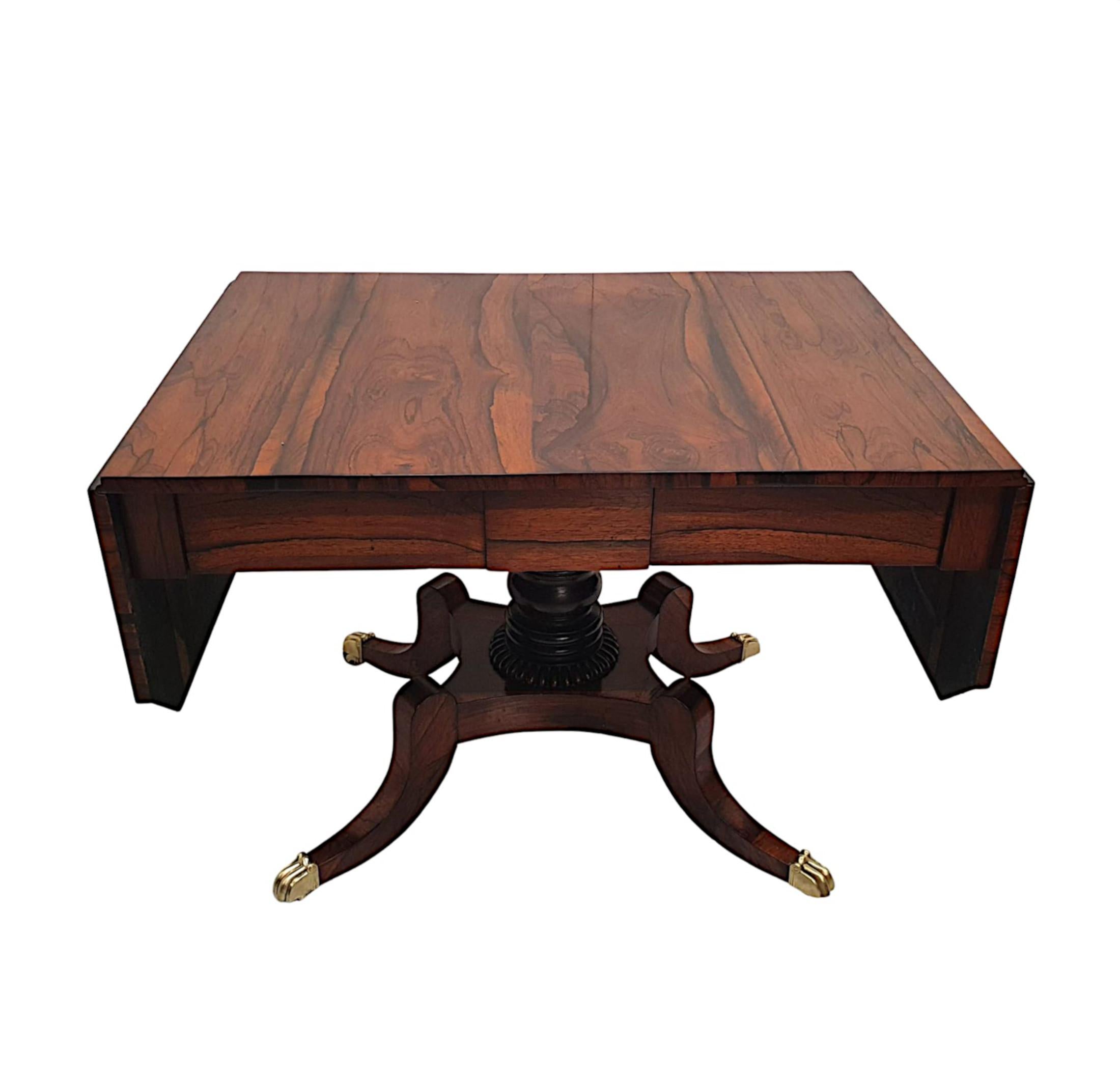 A very fine early 19th century Regency fruitwood sofa table, beautifully hand carved and of gorgeous quality with rich patination and grain. The well figured, moulded top of rectangular form with twin hinged drop leaves and canted corners, raised