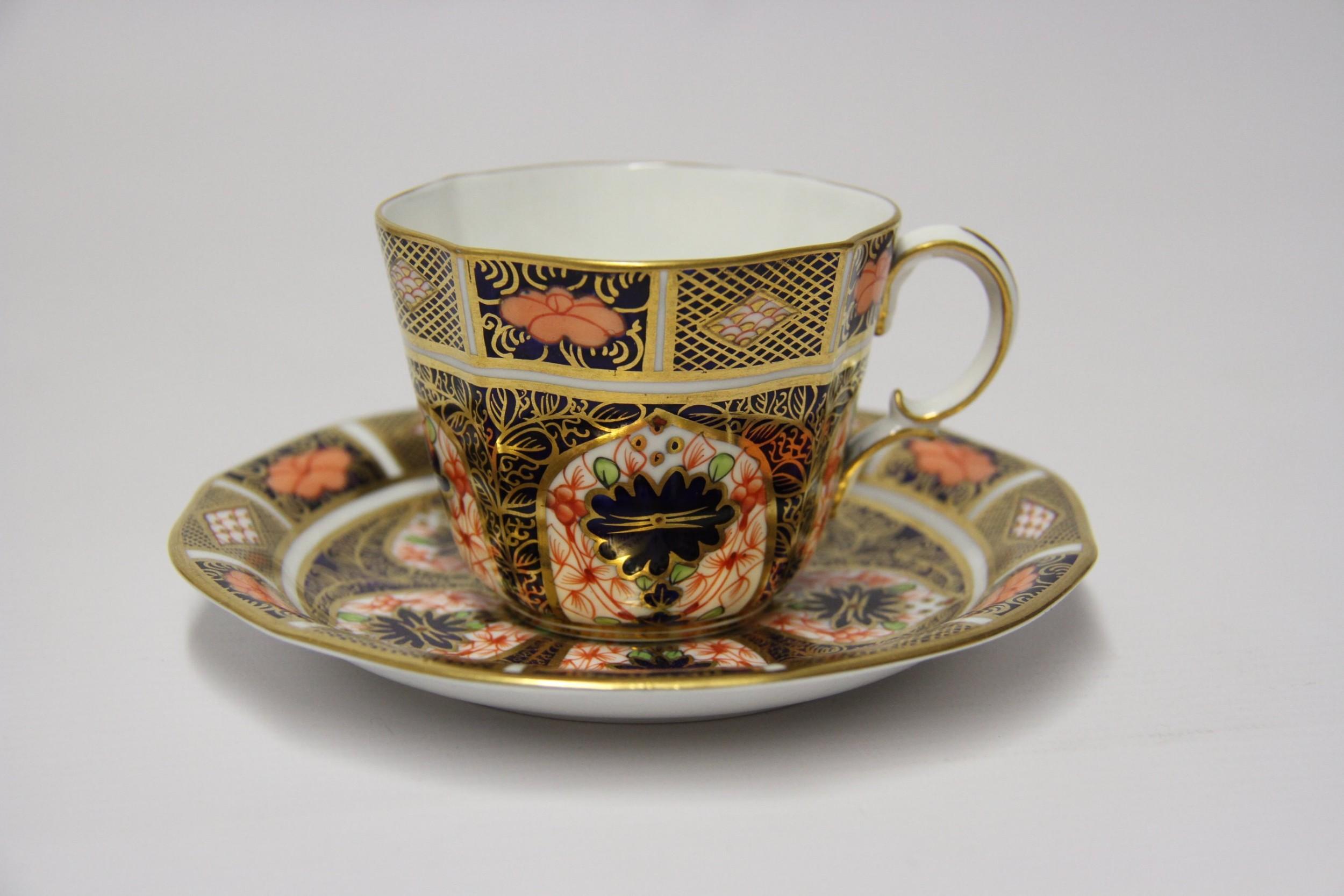 This Crown Derby tea set is in exceptional condition. It is a set of six hand painted and gilded tea cups and saucers with a decorative Imari design using a rich palette of colors. The tea set was made at the Royal Crown Derby factory in 1910-1911
