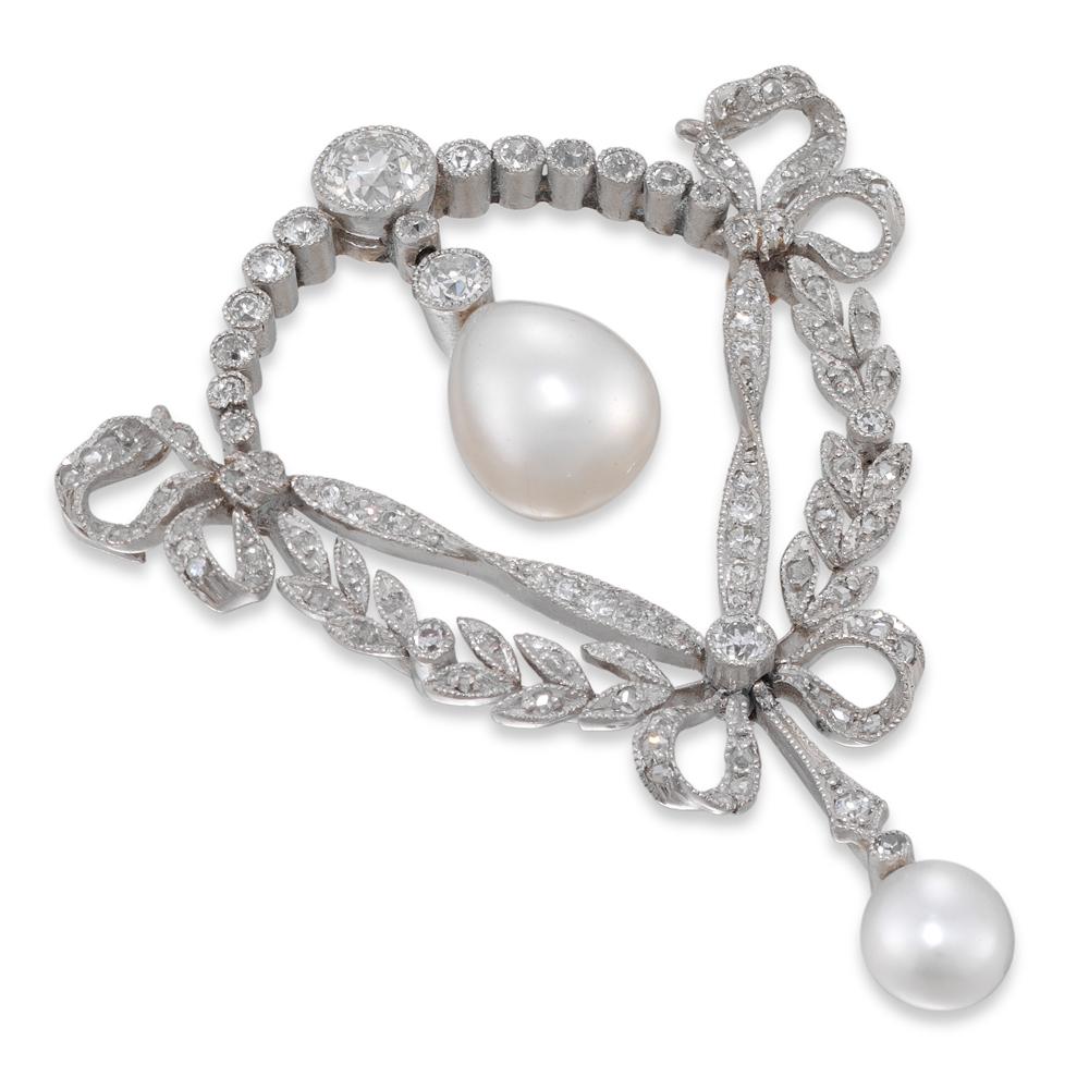 A fine Edwardian natural pearl and diamond, surmounted by a semi-circular run of diamonds with large old brilliant-cut diamond centre, dropping a pear-shaped natural pearl measuring approximately 10 x 8.2 mm, all to the centre of an openwork trefoil