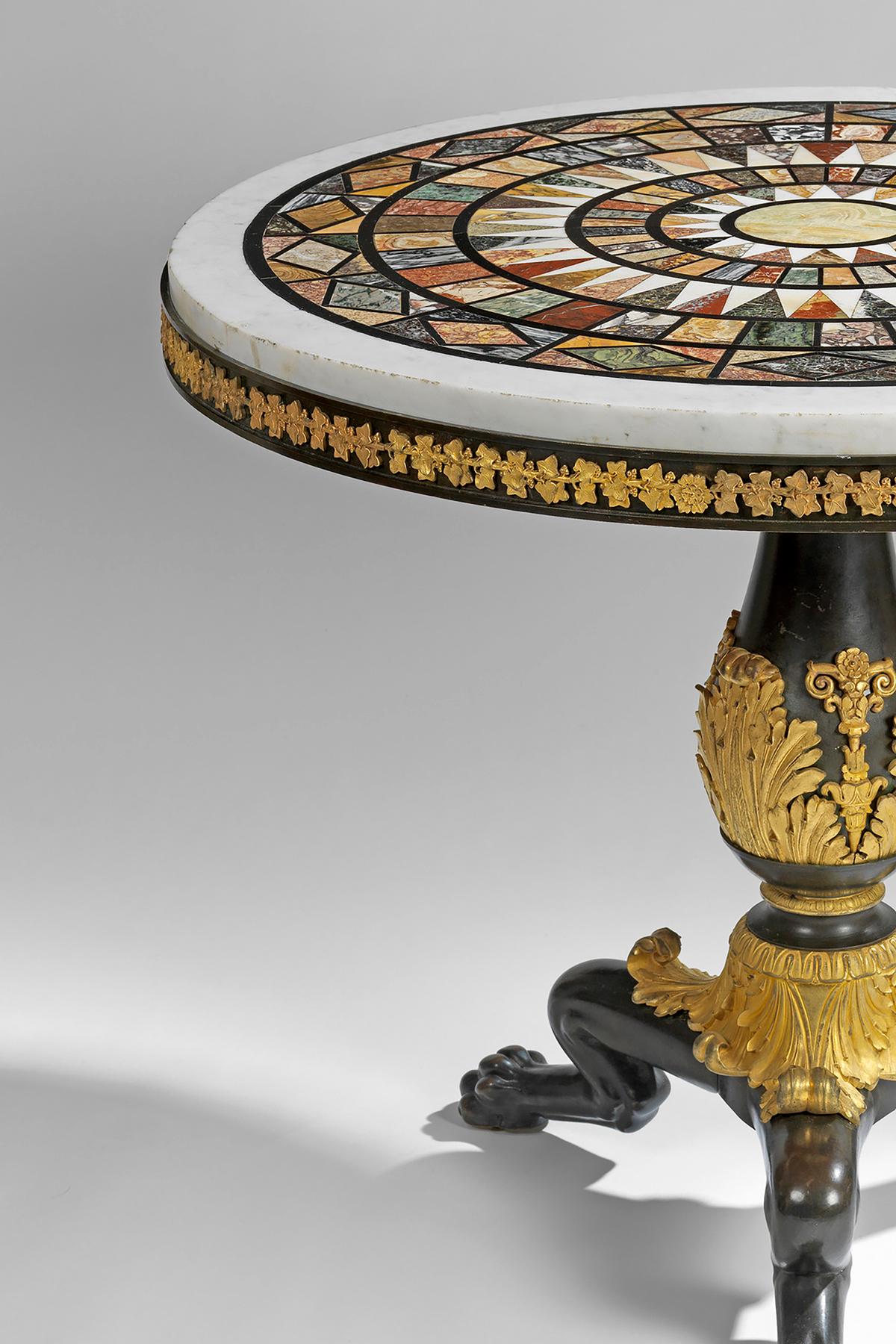 With a circular specimen inlaid white marble top, above a frieze cast with a band of vine leaves and grapes; the baluster stem, with a band of acanthus, supported by three griffin feet, cast with acanthus leaves. 

Items decorated with elaborate