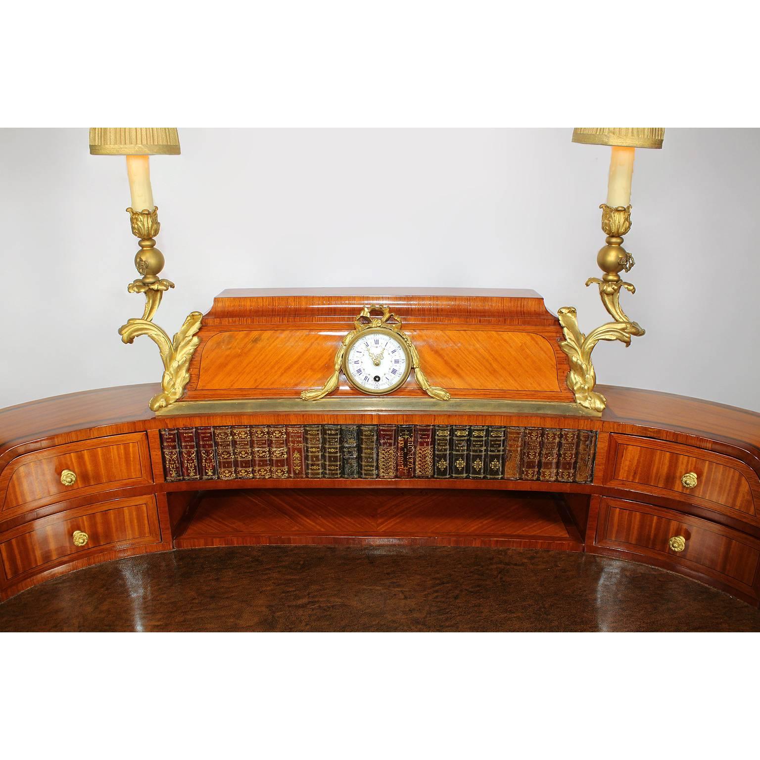A very fine French 19th century tulipwood, mahogany and ormolu-mounted Bureau de Dame Lady's secretary desk, attributed to Maison Millet. The superstructure centered by a clock with a porcelain face decorated with flower strands and Roman numerals