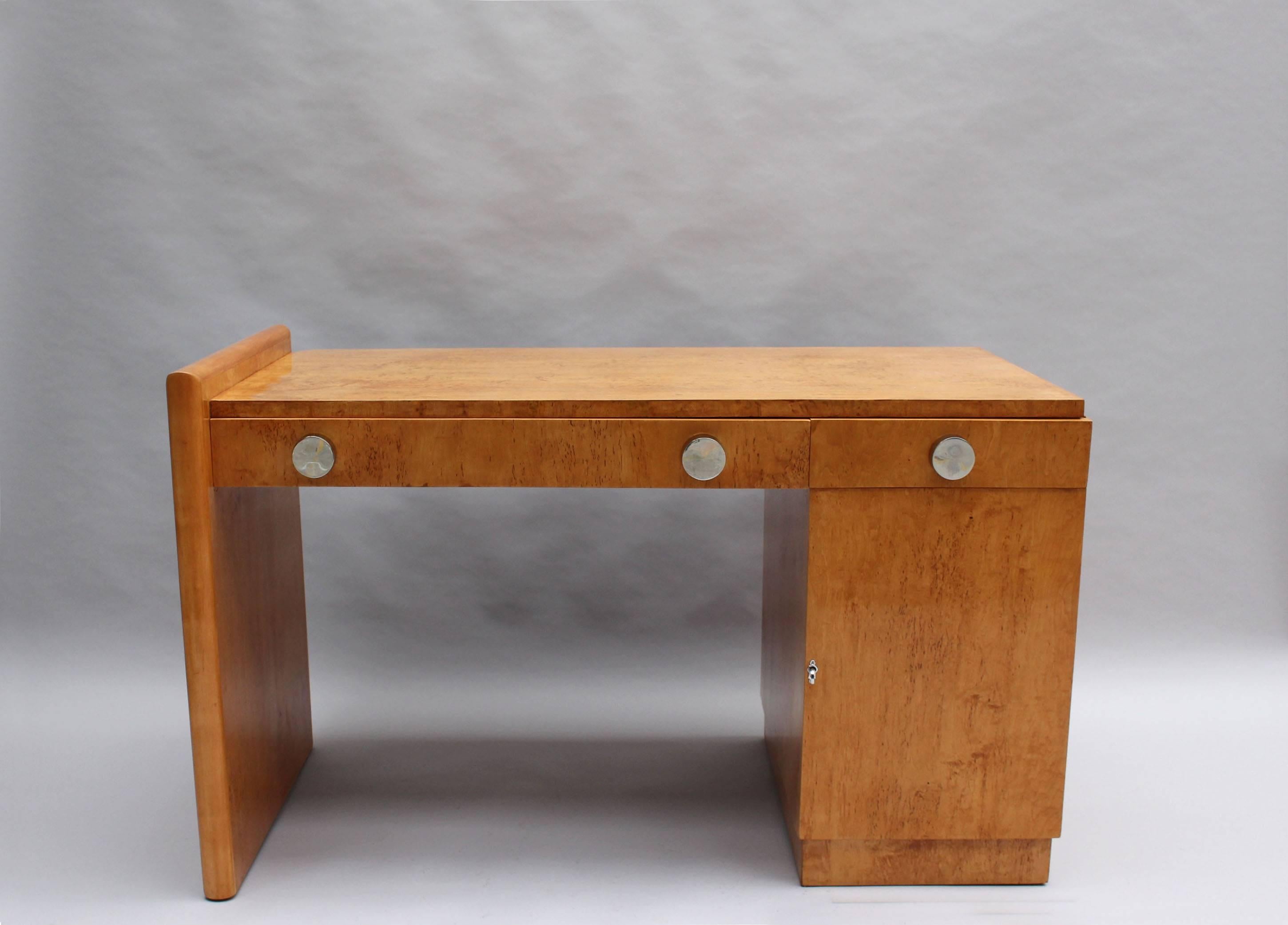 A fine French Art Deco two drawers and one door European burled birch desk with chromed knobs.