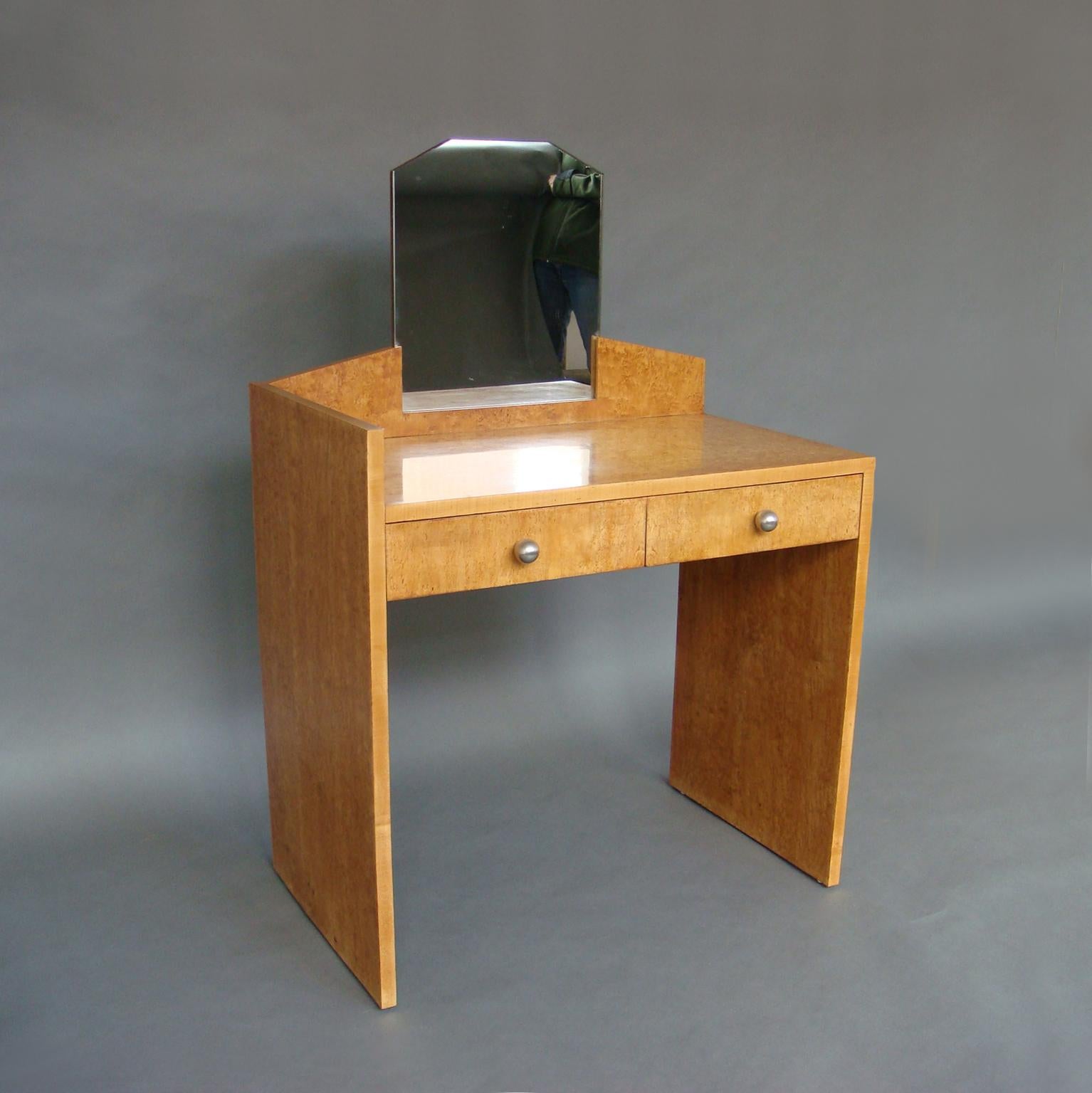 A fine French Art Deco European burled birch vanity with two drawers and chrome details. 

