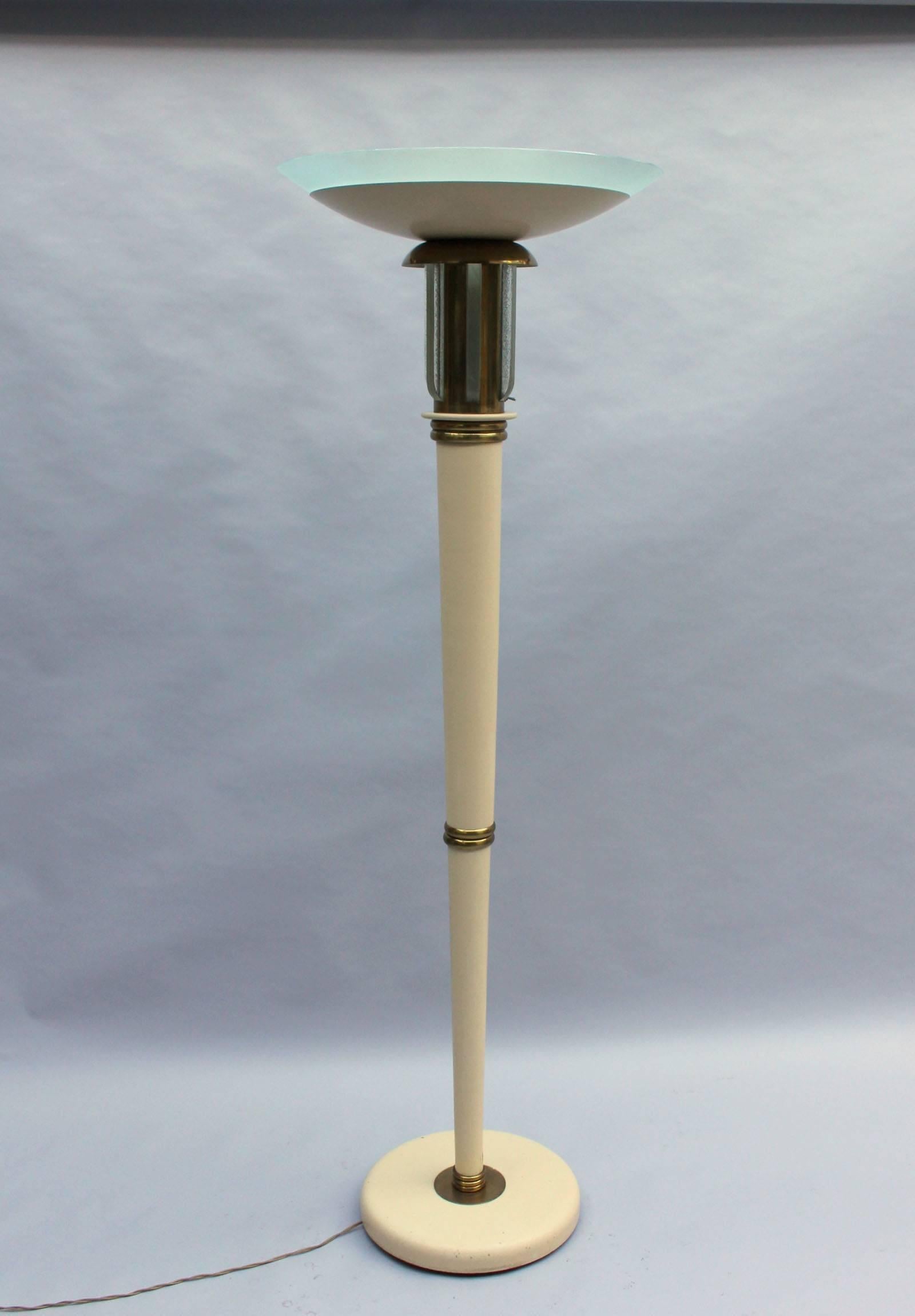 A fine French Art Deco lacquered metal and wood floor lamp with a glass bowl, glass diffusers and brass details.