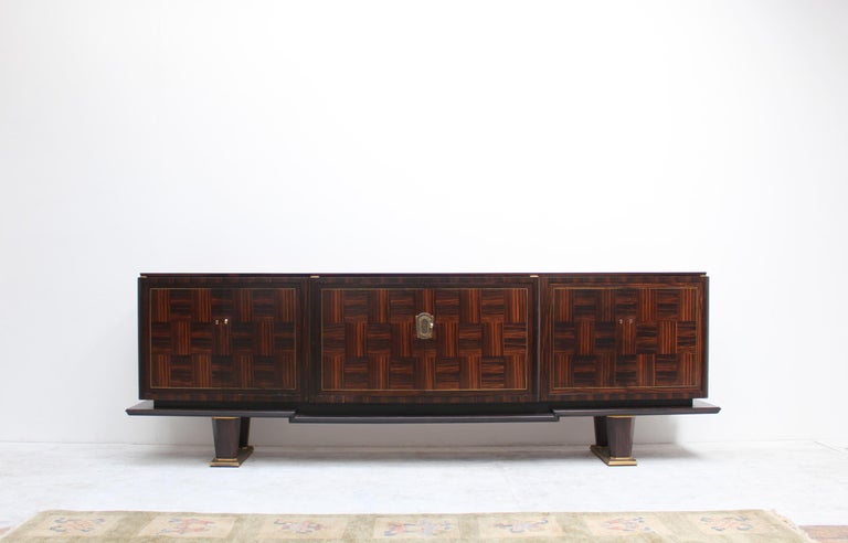 A fine French Art Deco 6 doors sideboard by Dominique in Macassar ebony marquetry with bronze details.
Interior in oak with shelves and drawers.
Signed.
 