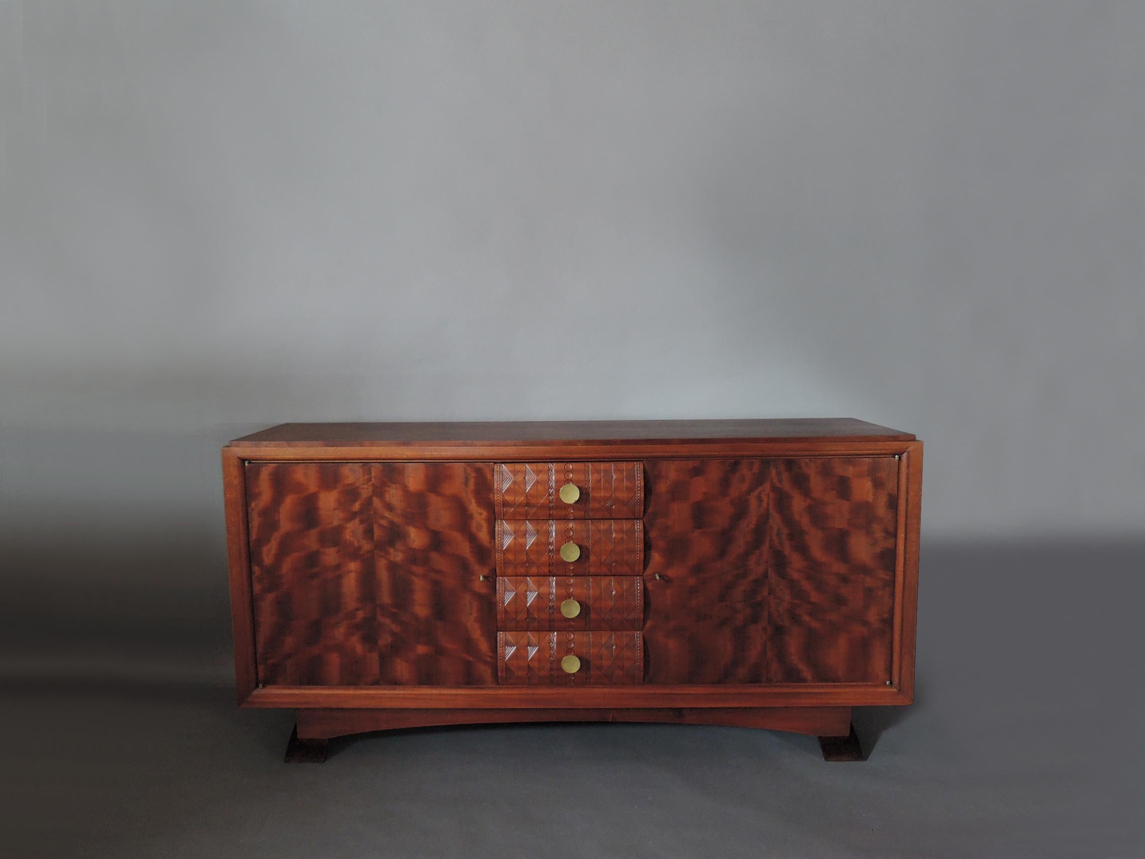Albert-Lucien Guénot (1894-1993): A fine French Art Deco sideboard with 2 doors, 4 carved drawers, and patinated bronze legs and knobs.
Edited by 