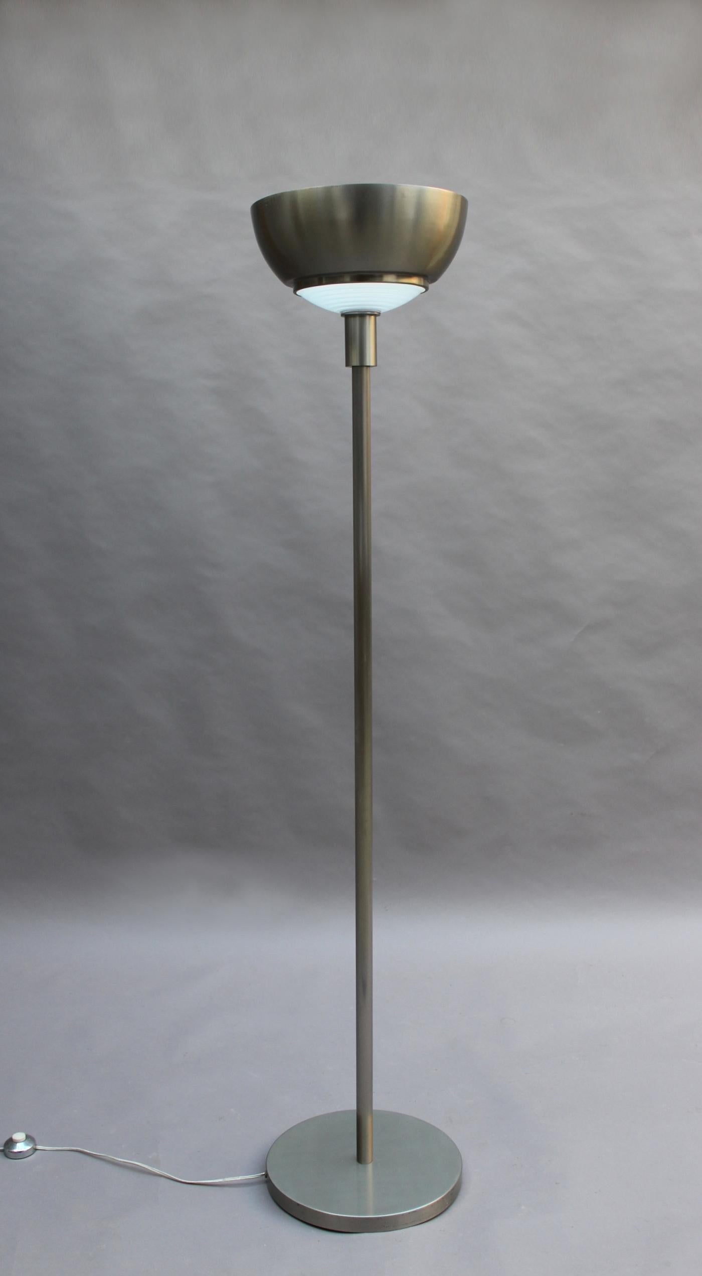 Eine feine französische Art Deco Stehlampe aus gebürstetem Nickel von Jean Perzel mit einer Fresnel-Glaslinse.