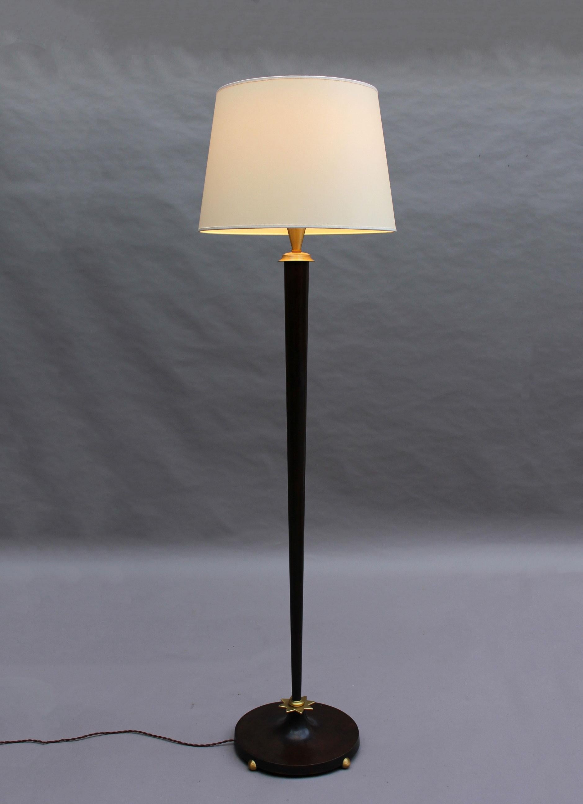 With a brown patinated round base and tapered stem, embellished with gilded accents, and a new shade.
  