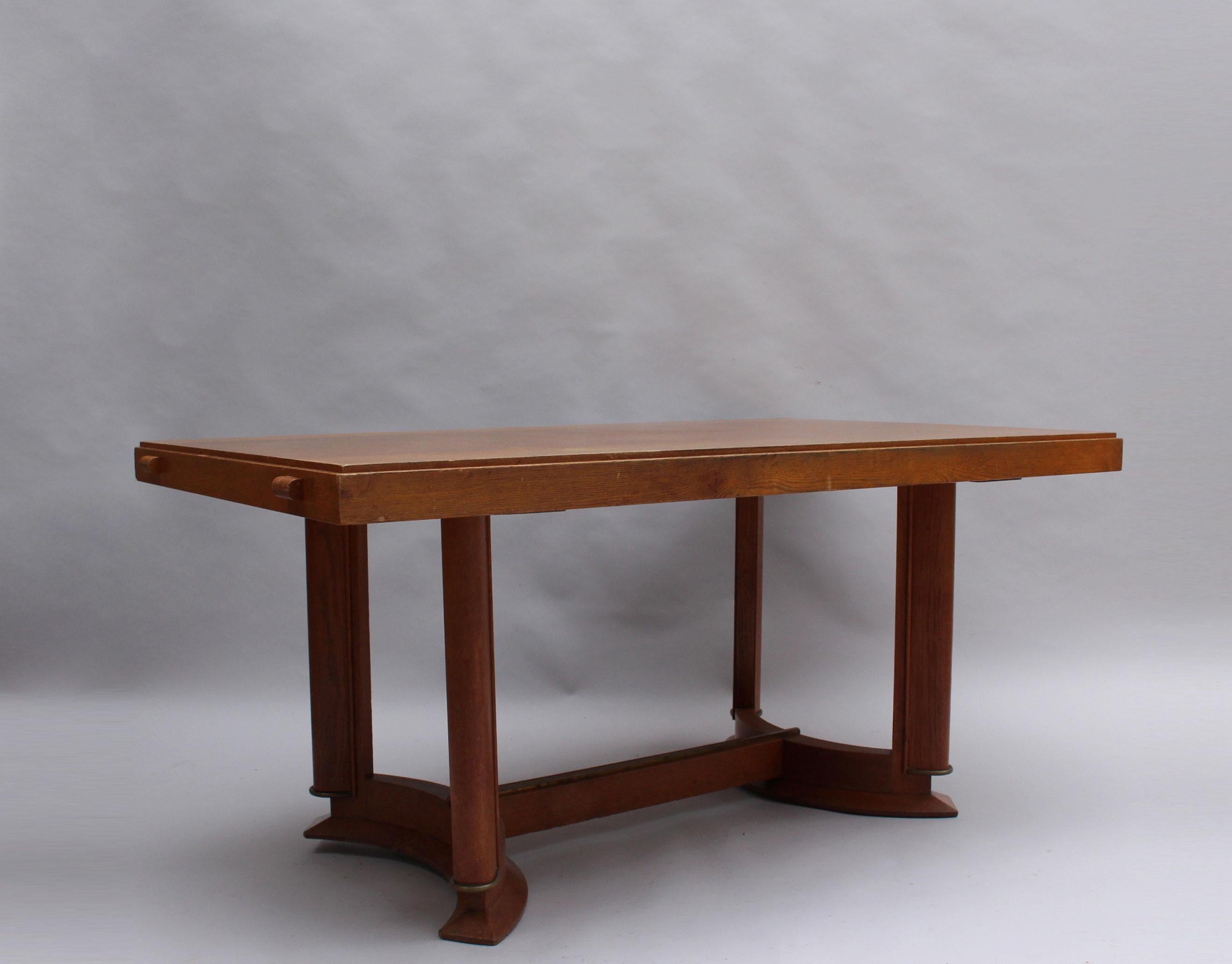 Rectangular top is supported by four legs with brass details and a dual arc-shaped base.
           