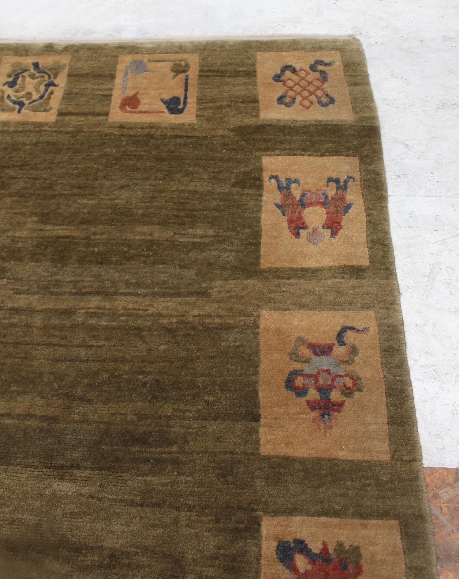 A fine Art Deco rectangular green hand wool rug with blue, red and beige motifs, in the manner of Leleu.
French design, most likely made in Nepal.