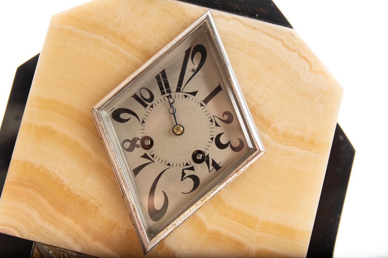 A superb Art Deco marble clock with triangular silvered dial with cascading black Arabic numerals. The case of Siena marble with black marble polished. The French movement striking the hour and half hour by Marti of Paris, France, 1920.