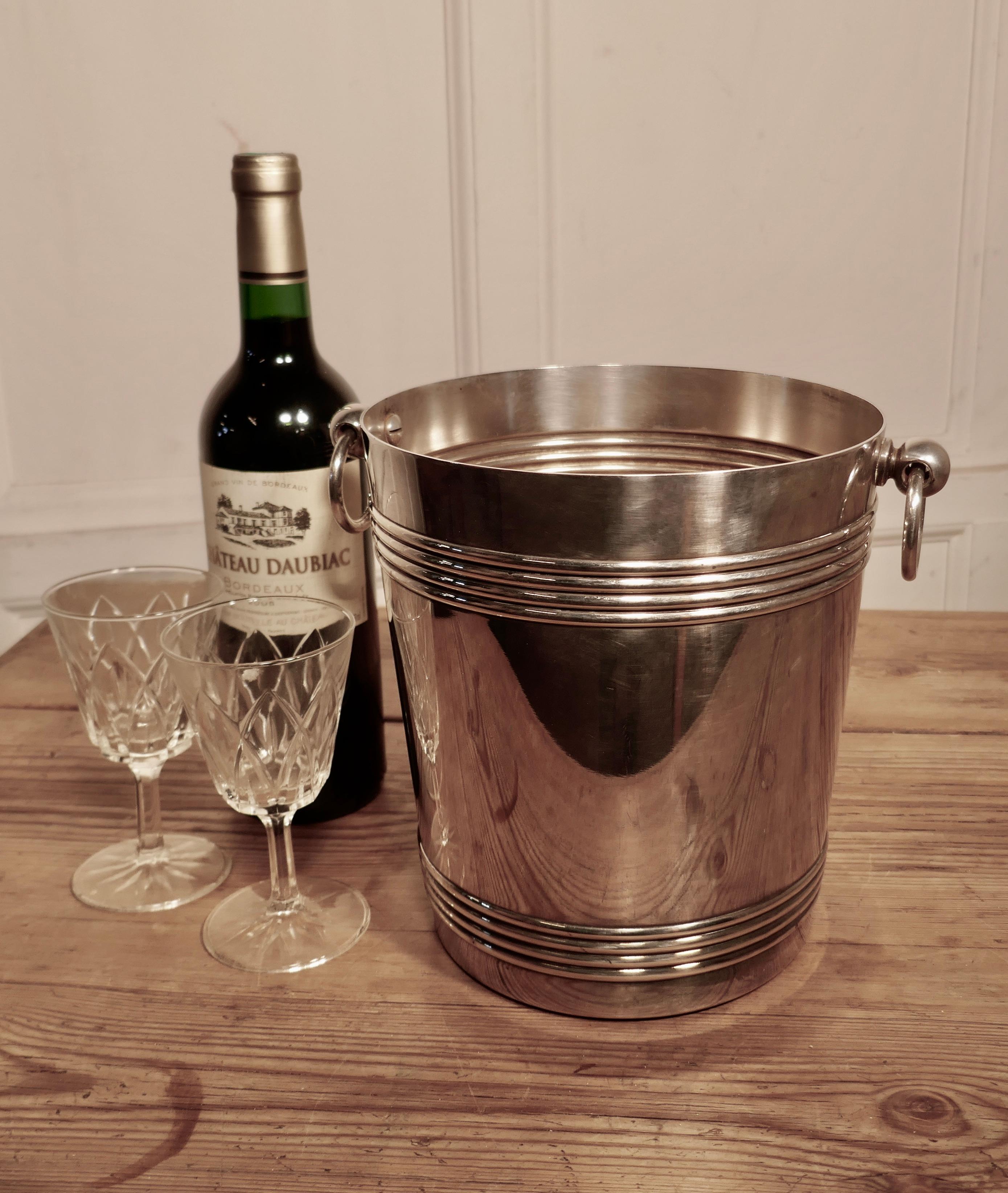 A fine French Art Deco style wine cooler, by Gallia

A very attractive vintage ice bucket in French silver plate by Galia, the cooler is straight sided, and has ring handles with a decorative reeding and around both top and bottom
This ice bucket