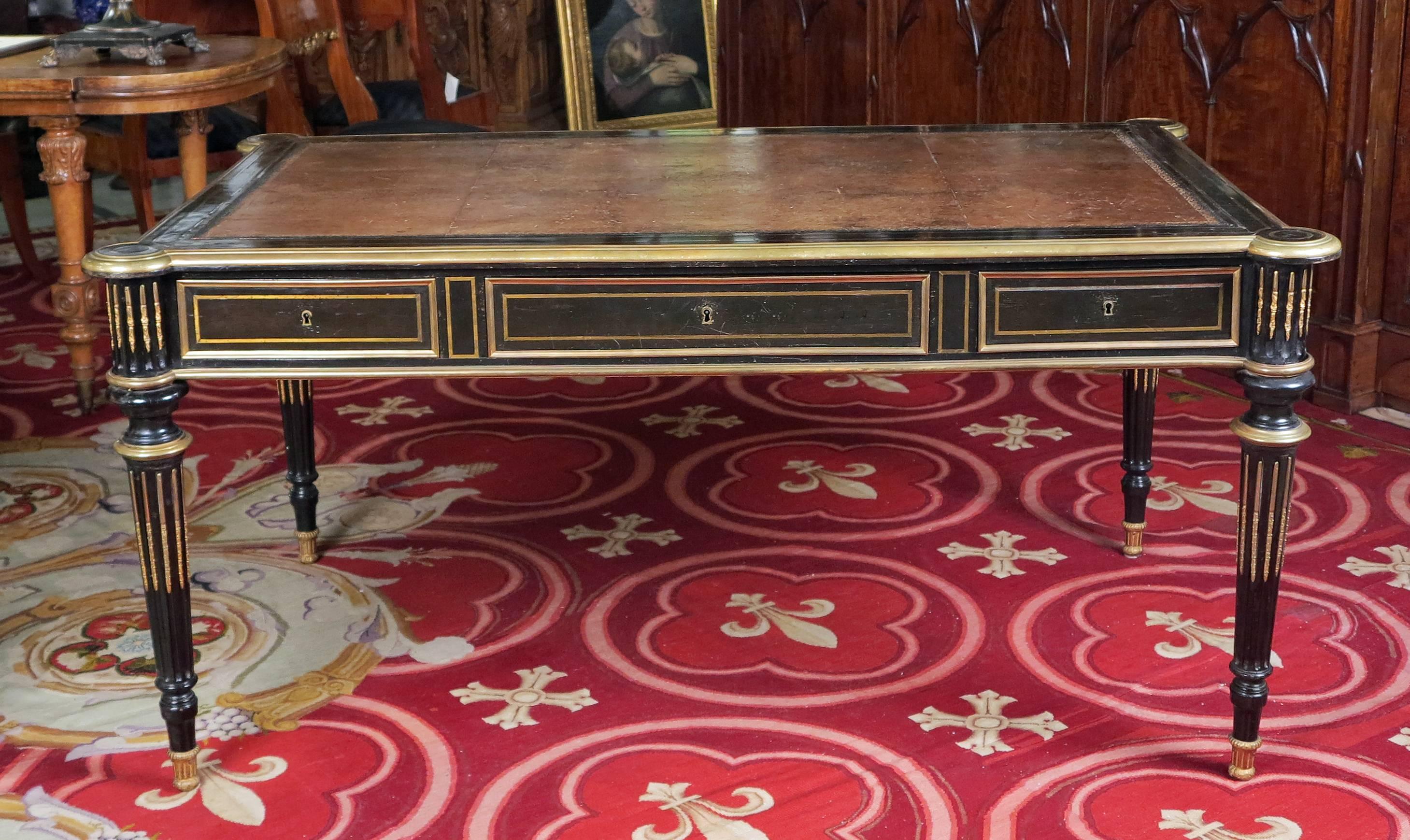 A fine French ebonized and brass inlaid bureau plat
By Etienne Vieux
Maitre, 1855-1880,
circa 1860.

A leather inset with a tooled edge above three drawers on rounded tapered fluted legs ending in castors.
The central lock stamped “Vieux F.