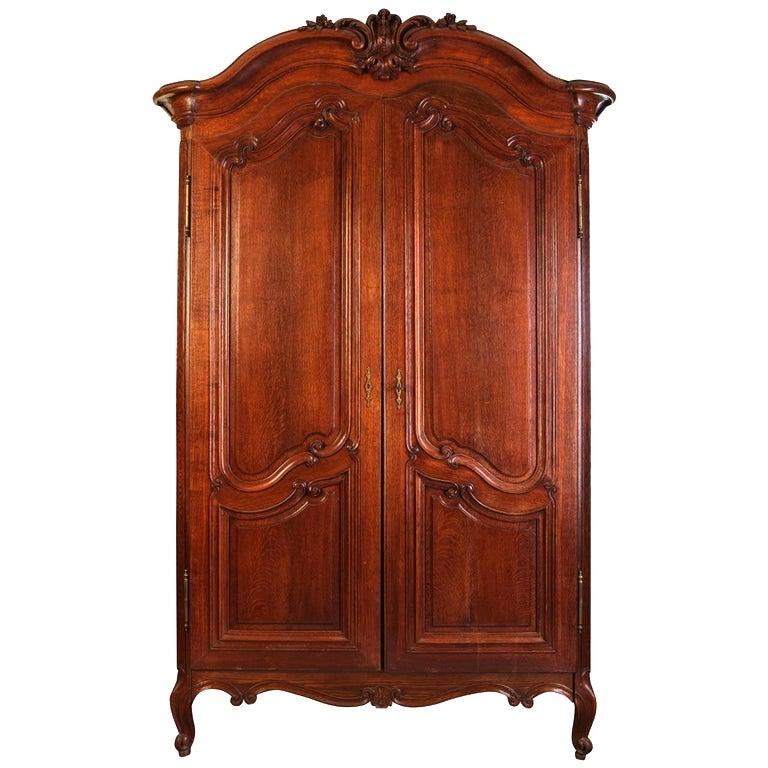A Fine French Louis XV period, carved,  solid walnut , Bordelais Armoire that opens with two beautifully paneled doors.