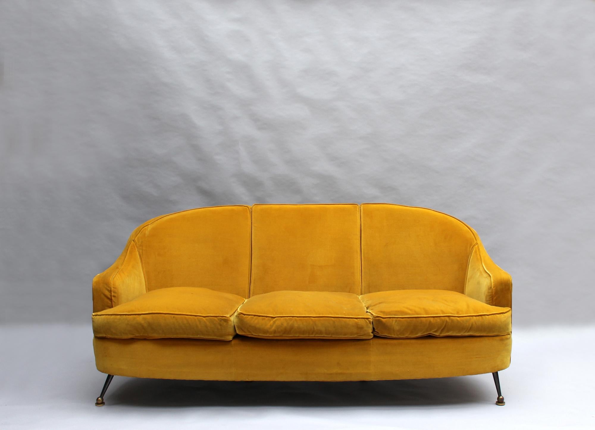 Maison Leleu - A fine French 1960s three-seat sofa with elegant brass and gunmetal legs.

Documentation:
Magazine 