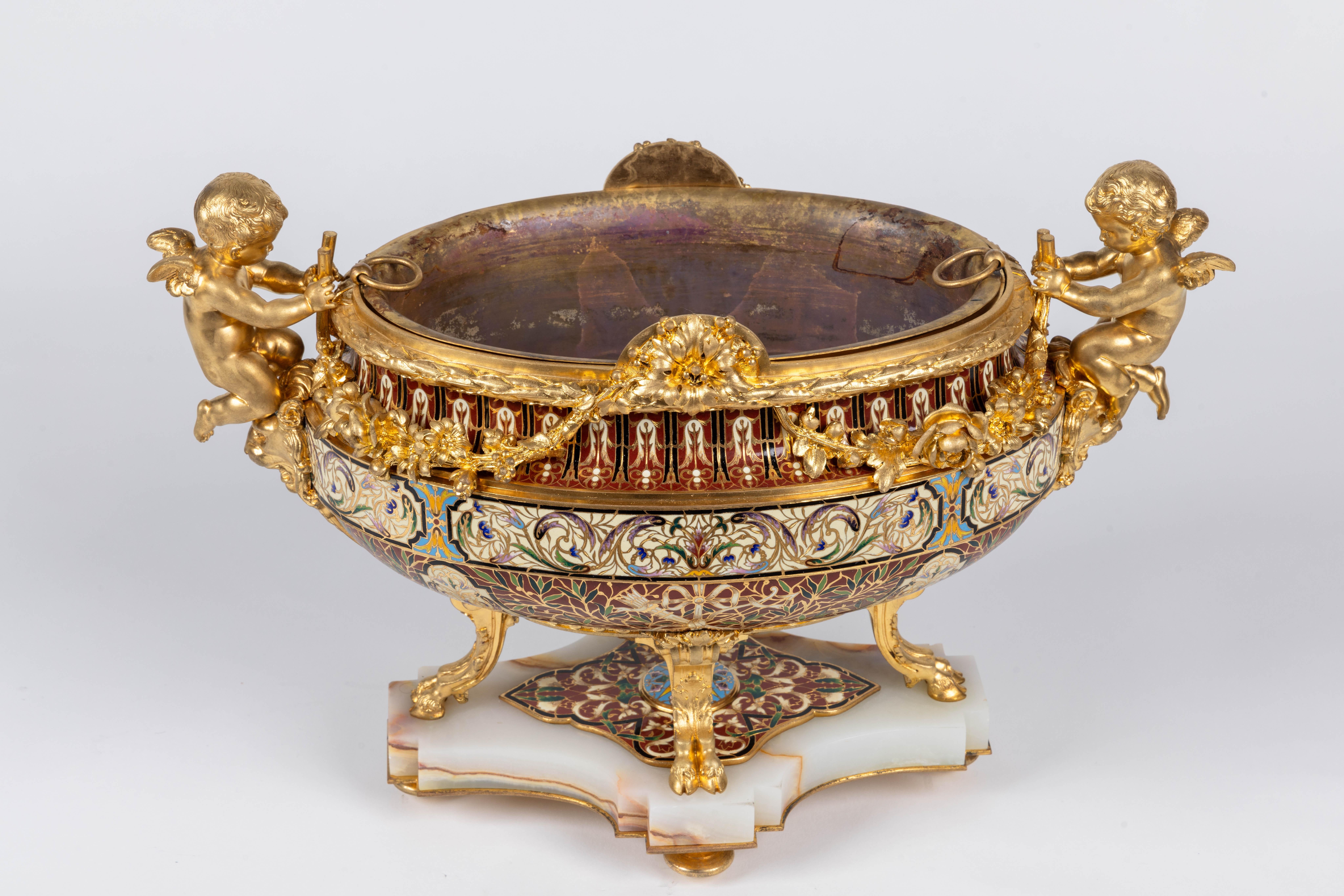 A truly exceptional French ormolu, champlevé enamel, and onyx jardinière centerpiece. This magnificent piece epitomizes the opulence and elegance of the Belle Époque era, combining exquisite craftsmanship and luxurious materials to create a