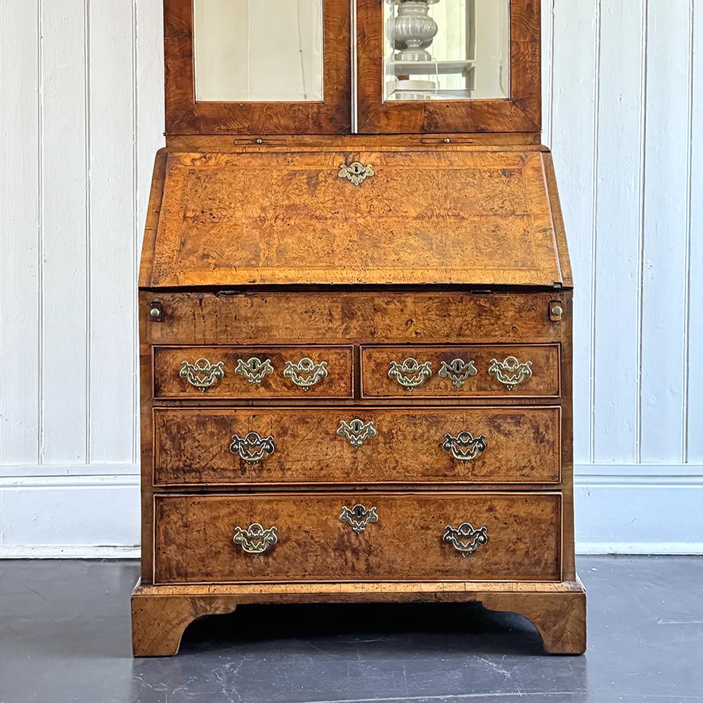 An exquisite George II period walnut bureau bookcase of exceptional colour, grain, and patina, dating to circa 1740. The upper section is adorned with refined mirrored doors, which open to reveal a beautifully fitted interior complete with an