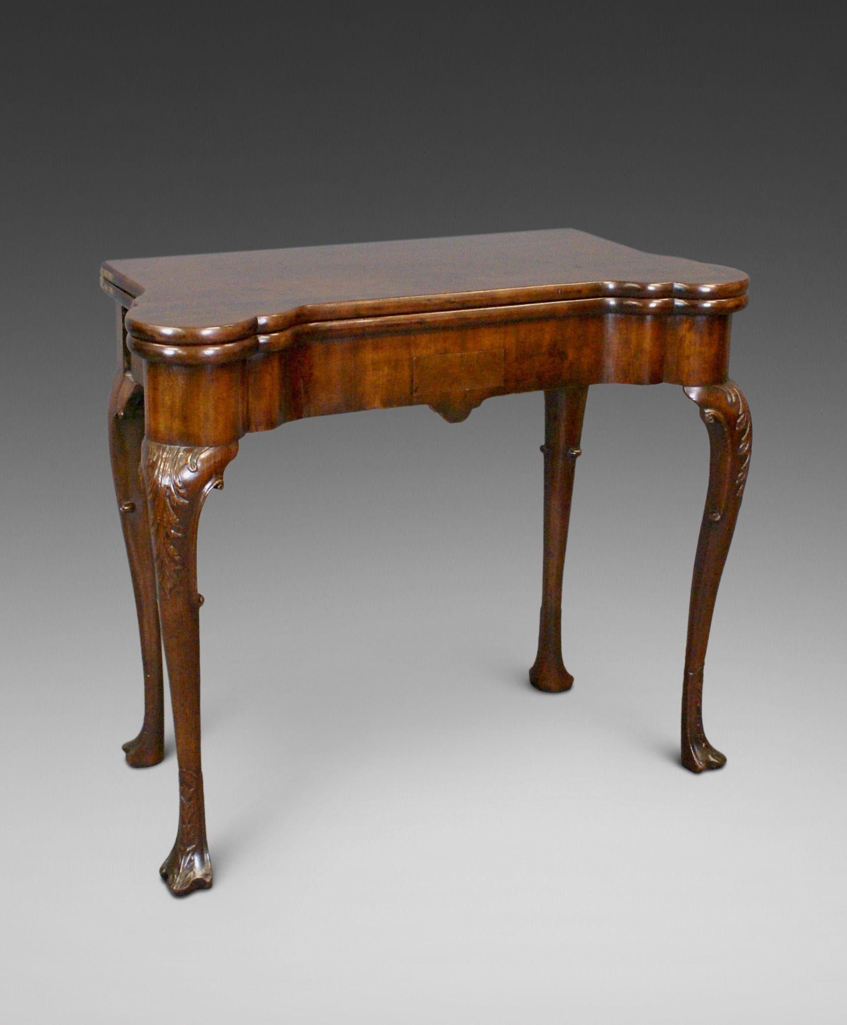 A fine George II Period mahogany carved cabriole leg tea table. Raised on cabriole legs with acanthus leaf carved knees and pad feet. The boldly shaped frieze has a small oak lined drawer and the top is of 