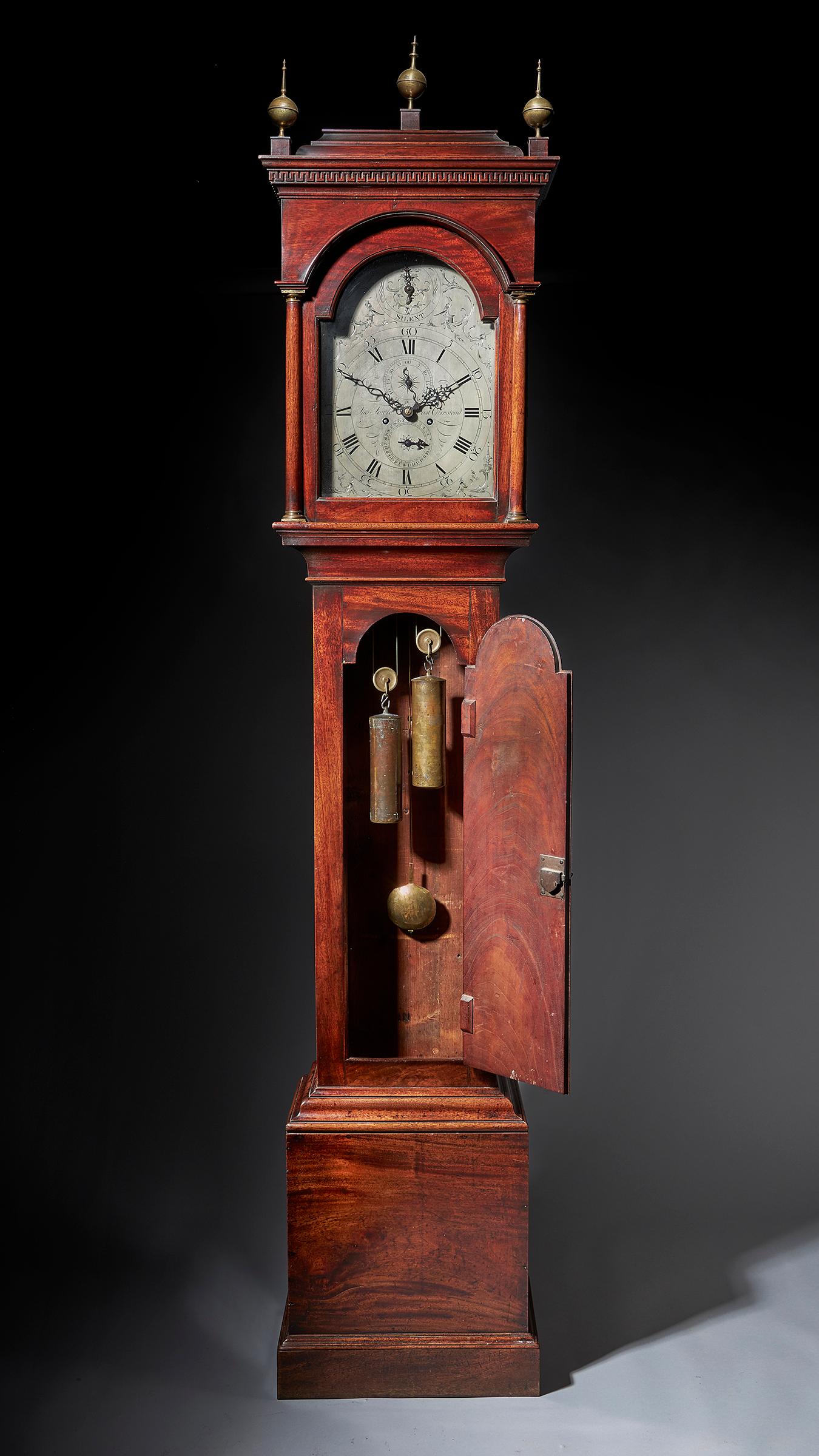 A fine George III period mahogany longcase clock of excellent colour, patination and proportions, circa 1780-1790

Surmounted with three ball and spike brass finials, the inverted bell top hood is decorated with a Greek key frieze below an ovolo