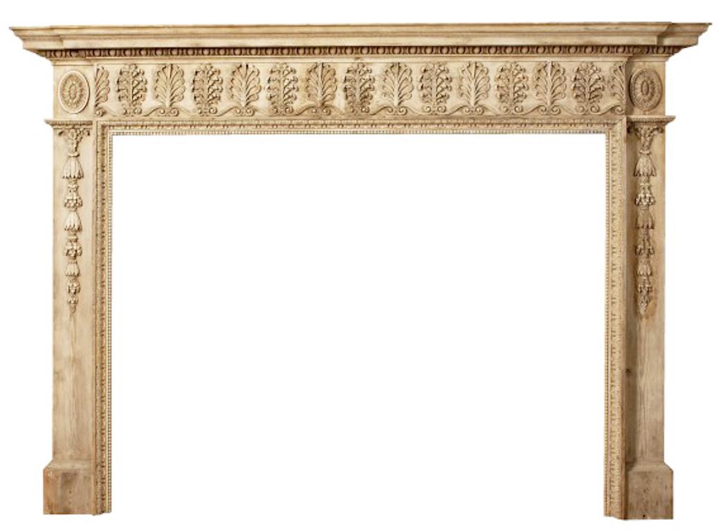A fine George III English pine fire surround with carved lime wood decoration.

The frieze decorated with carved honeysuckle and acanthus, leaf pateras above jambs decorated with foliate drops. Circa 1780.

Salvaged from Hammer Hill House.