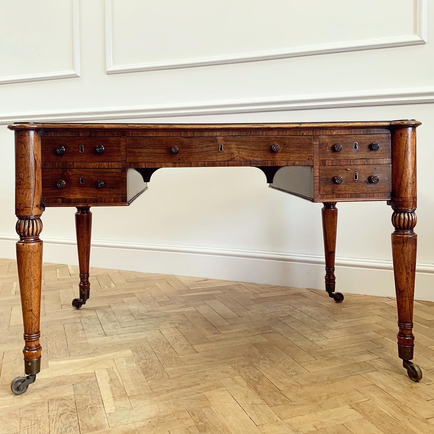 A fine George IV coromandel free standing desk with inset teal leather skiver decorated with gilt Greek key border, supported by four four solid coromandel turned legs of exceptional graining terminating in best quality brass castors - faux drawers