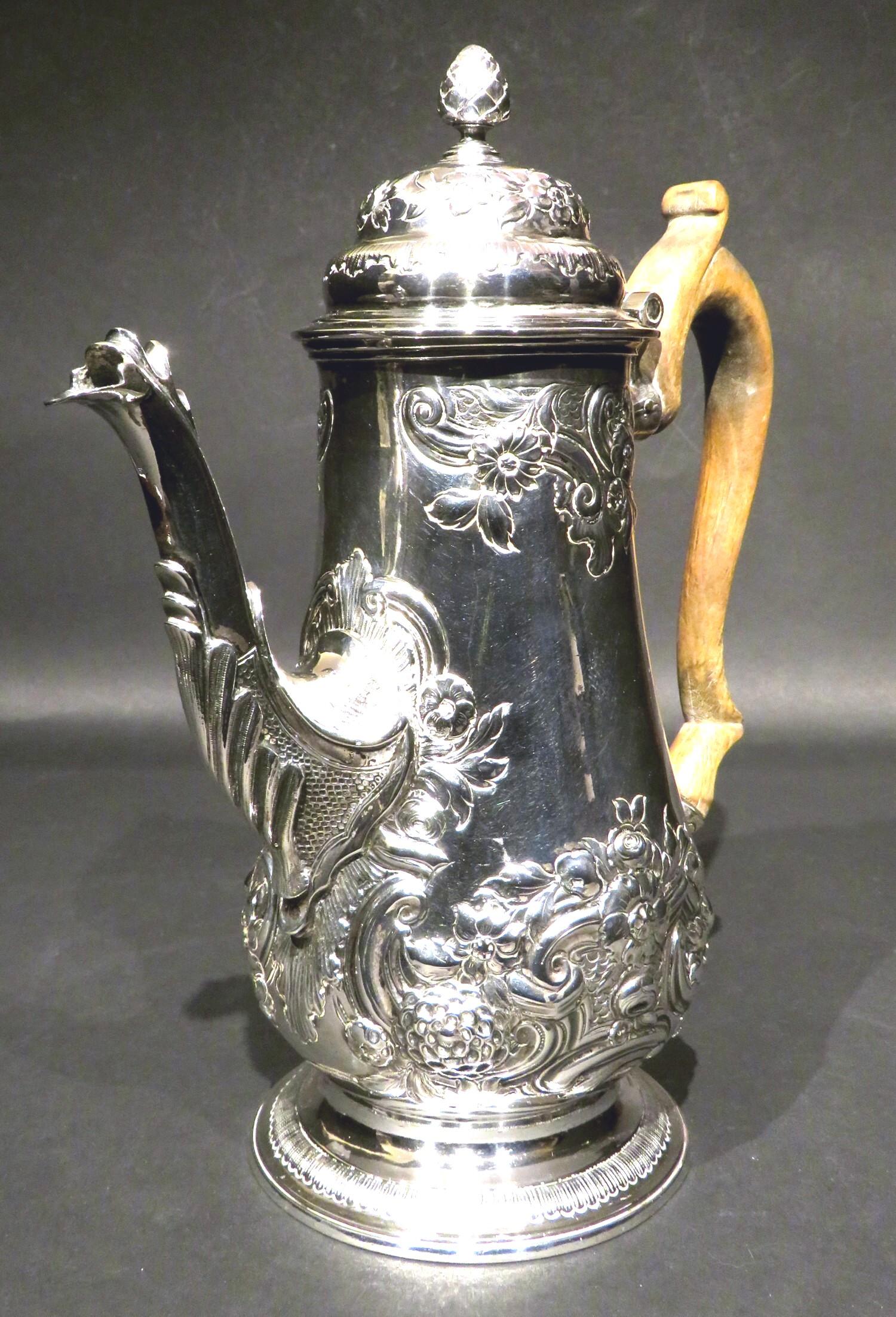 A fine Regency Period / George IV sterling silver coffee pot of baluster form, bearing partially rubbed London hallmarks with date letter for 1819 and makers marks for William Bateman 1st above a heraldic crest. 
Richly embossed overall with
