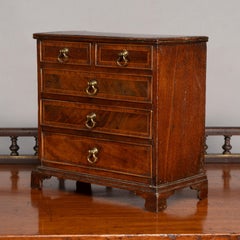 A fine Georgian walnut miniature chest of drawers