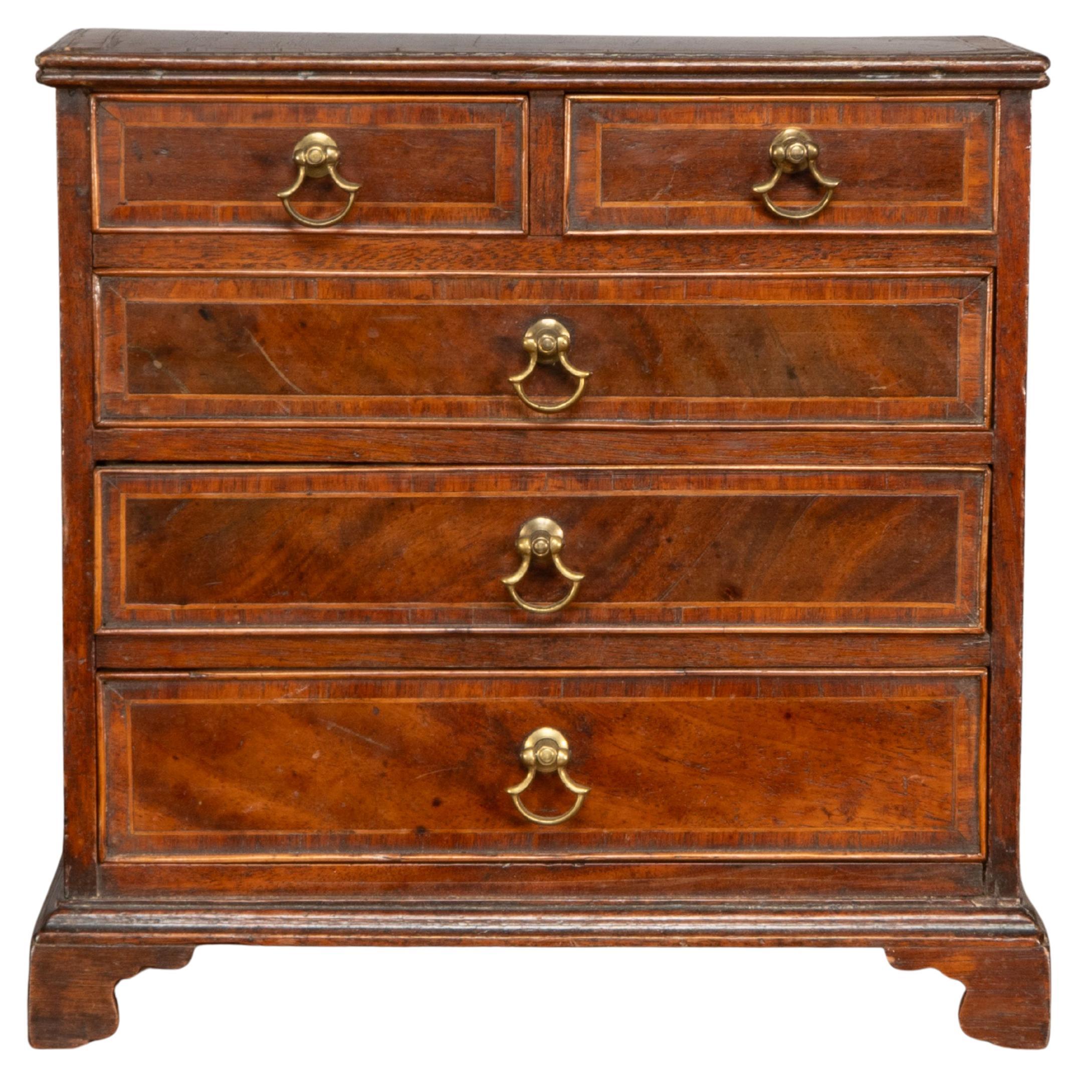 A fine Georgian walnut miniature chest of drawers