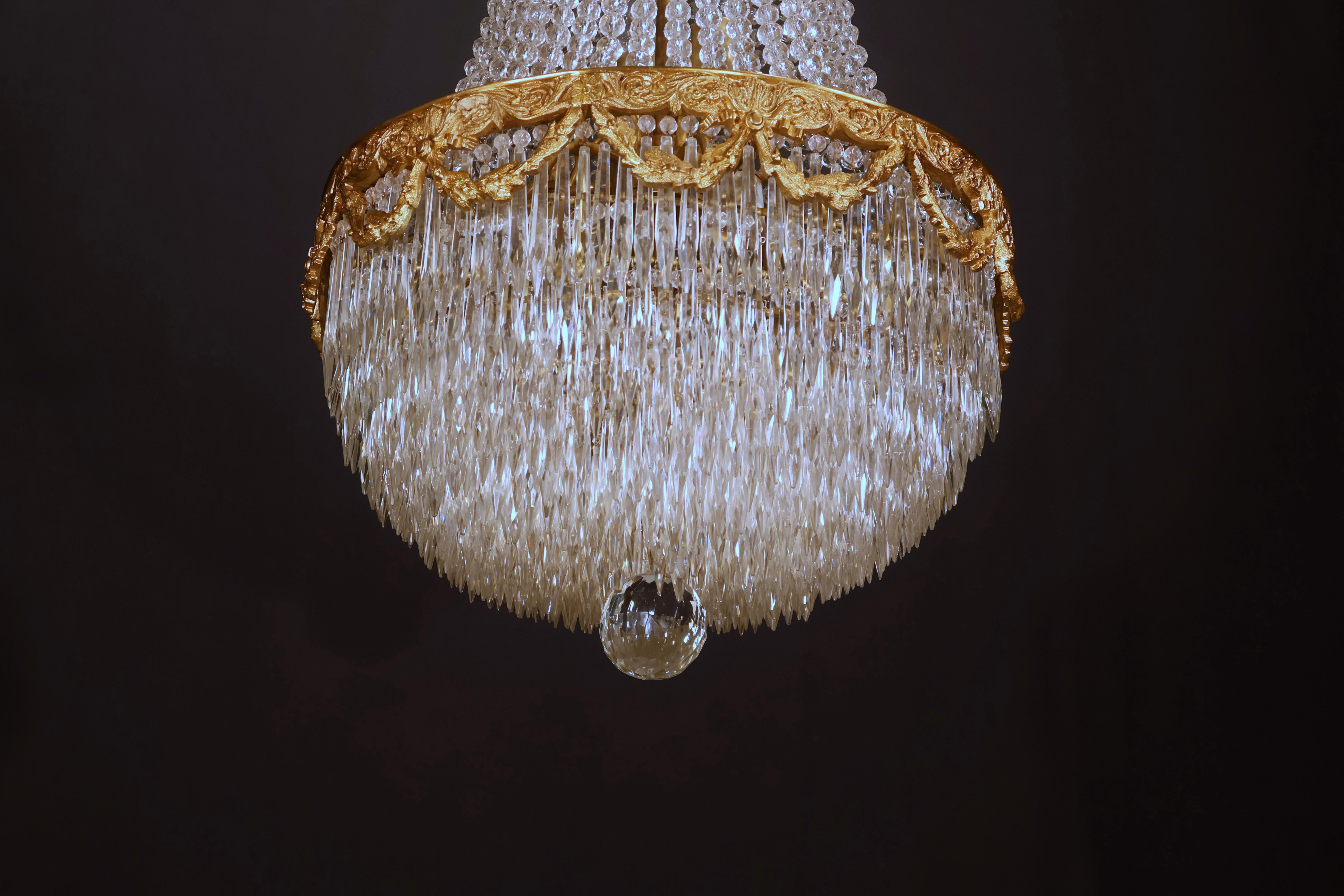 A Fine Gilt Bronze & Crystal Chandelier by Baccarat. The bottom section are concentric rings featuring crystal icycle prisms. 8 lights. France, circa 1910.
Dimensions: Height 45
