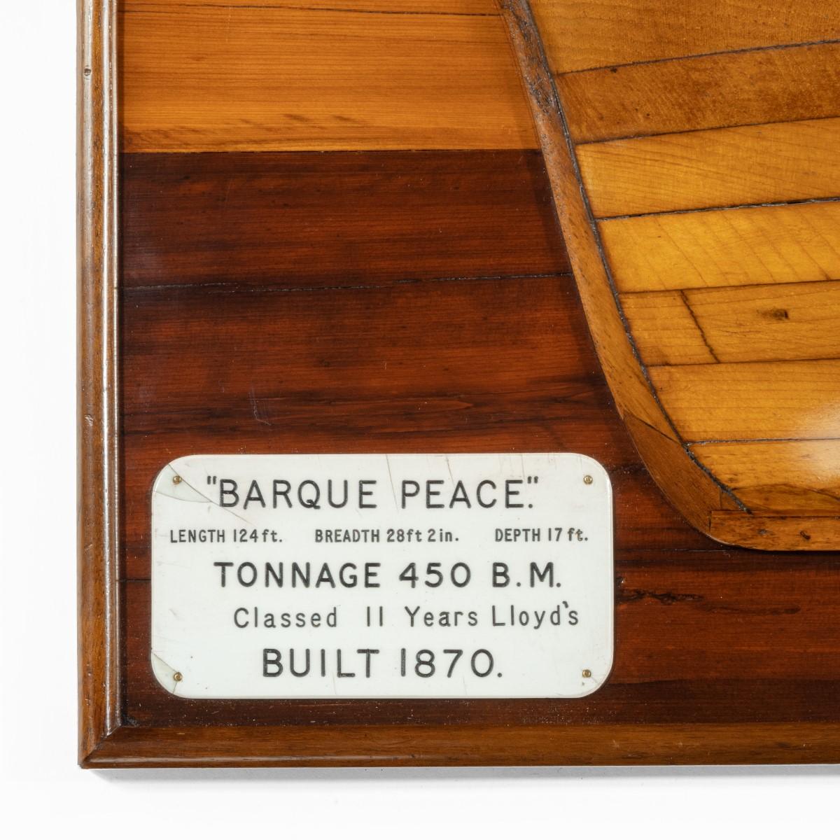 A fine half hull model of ‘Barque Peace’, the planked hull set on a stained yew wood backboard, with a plaque reading ‘”Barque Peace” Tonnage 450 B.M. Classed II Years Lloyd’s Built 1870.’ British.
   