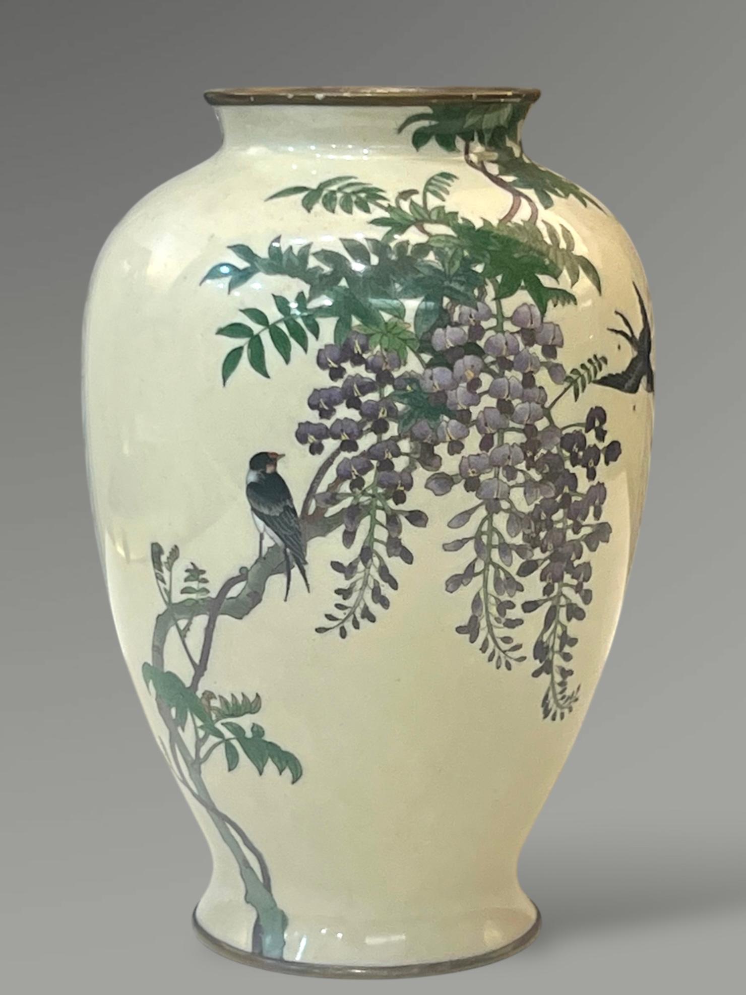 
A Fine Japanese Cloisonné Enamel Vase with Swallows and Wisteria, Signed Goto


Meiji Period (c. 1890–1910)



Worked in silver wire , of ovoid form with gently flaring foot and rim, set on a gilt metal base. The body is finely decorated with a