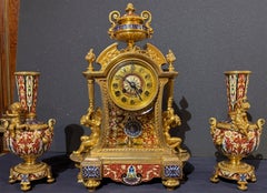 A Fine Japy Frères Gilt Bronze and Red Enamel Champlevé Garniture Clock Set