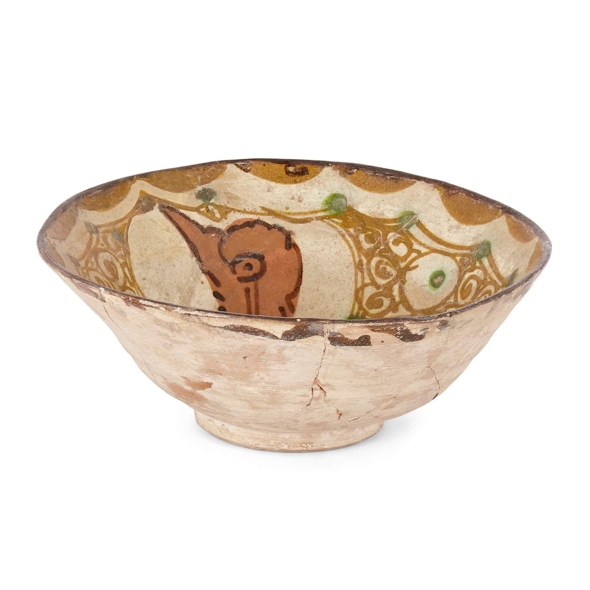 A fine kashan pottery ceramic bowl
Persian, 13th century
Measures: Height 7.5cm, diameter 19cm

Depicting a bird, this charming piece is an example of 13th century Persian Kashan pottery. Kashan was one of a number of historic pottery production