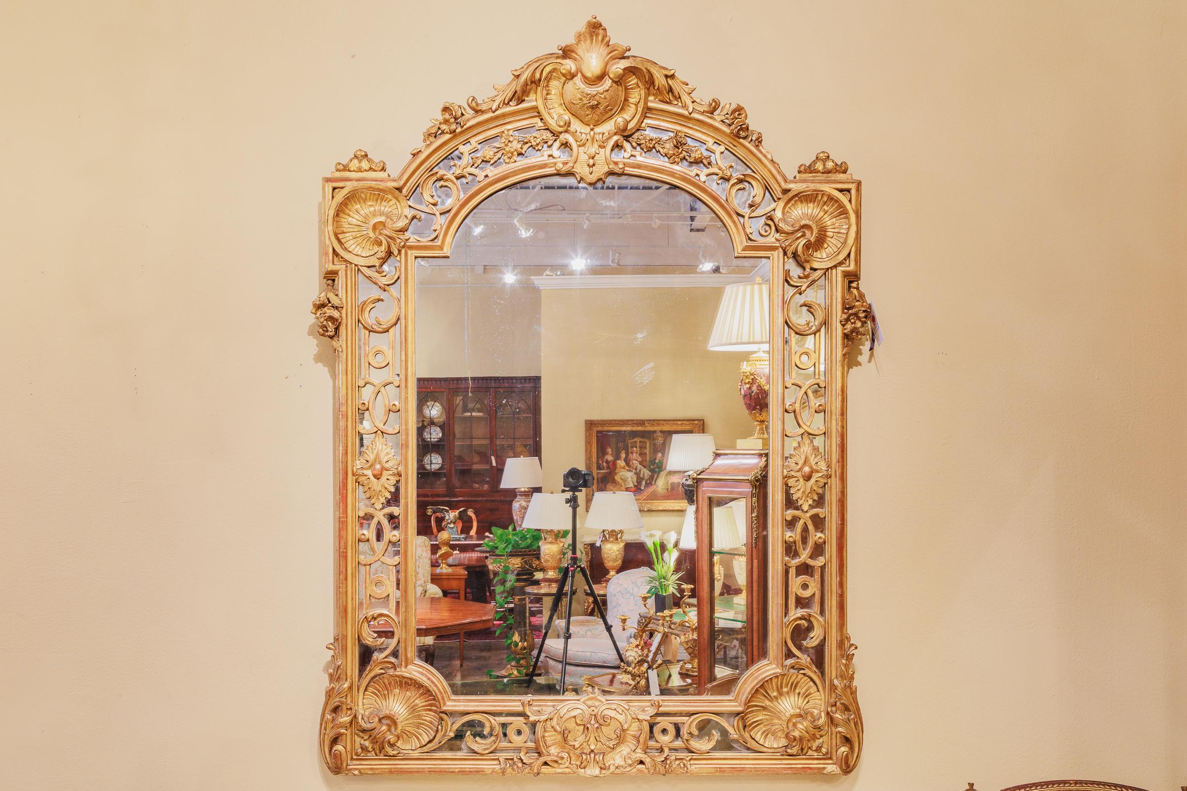 A very fine 19th century French Regence gilded and hand carved large mirror. Finely detailed. Original gilding.