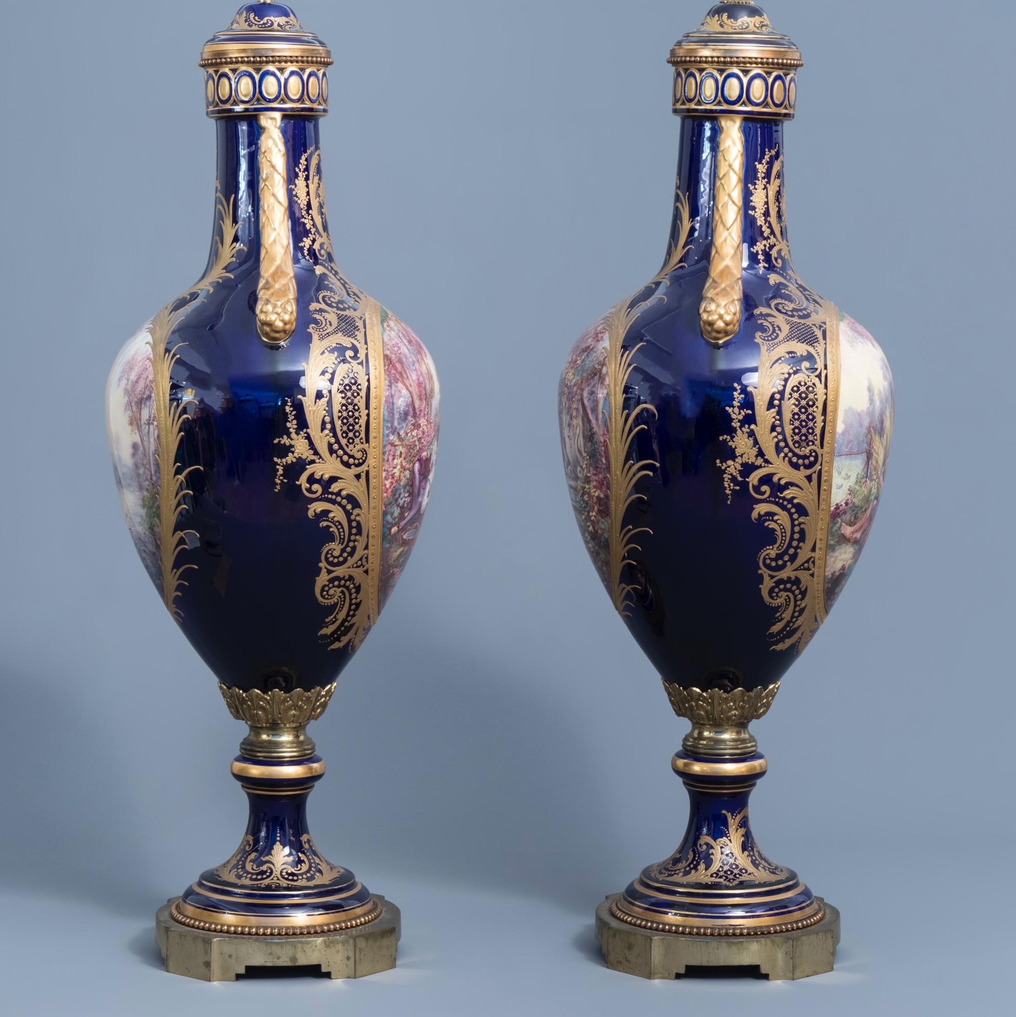 A large pair of French Sevres styles vases, the front of the vases decorated with gallant scenes while the reverse decorated with landscapes, covers stamped with a Sevres marks, The gallant scenes signed 'J. Pascot.